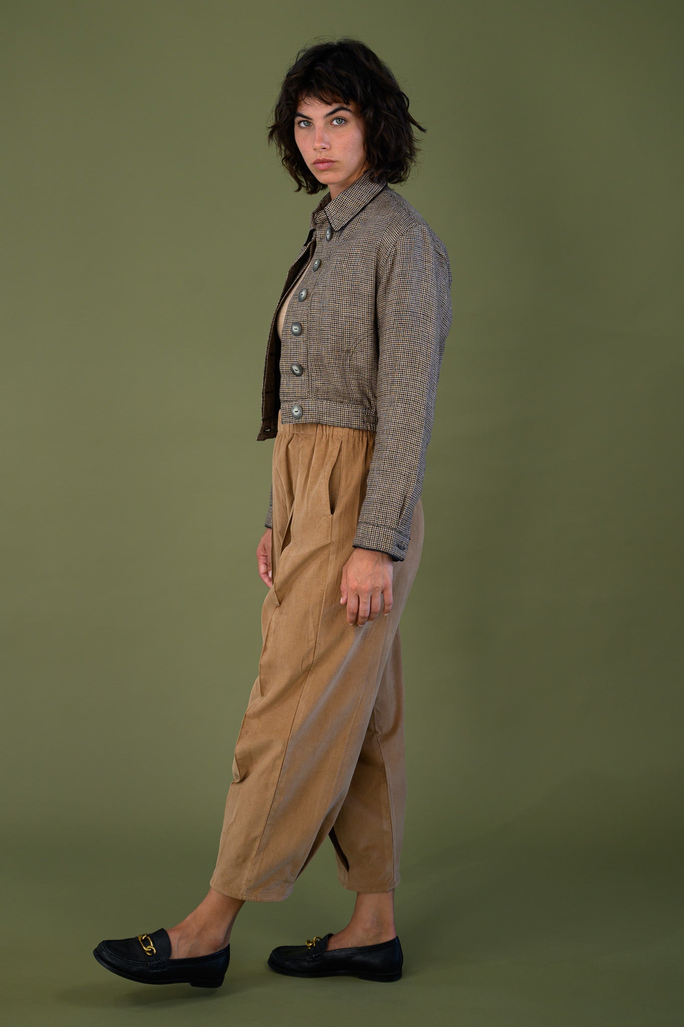 Side profile of cropped check jacket with elastic waist showing fit and proportion with relaxed pants