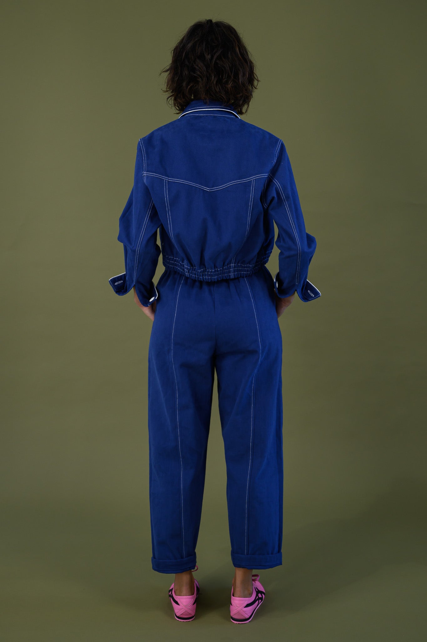 Back view of French navy cotton twill button pants styled with matching jacket full length