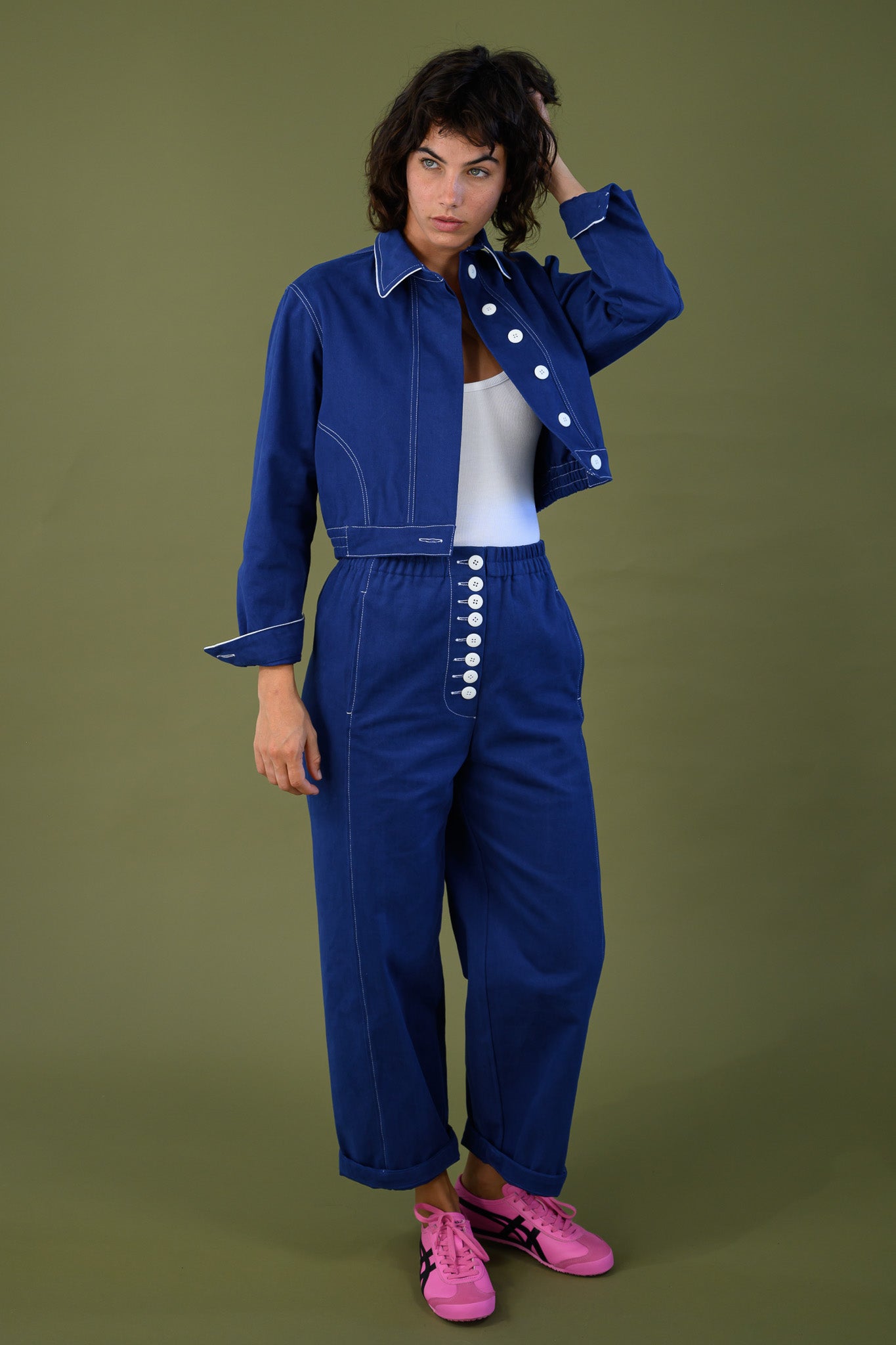 French navy cotton twill button pants shown full length on model styled with matching jacket