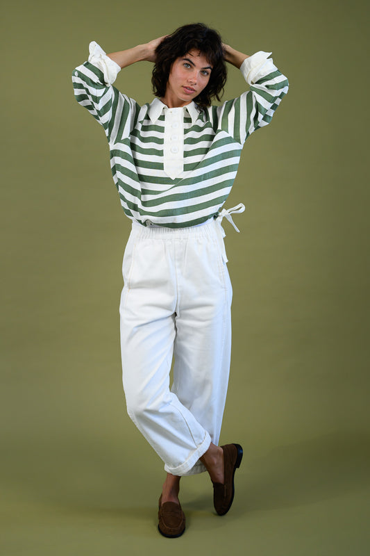 Harrington shirt meadow green stripe linen full body front view styled with white pants showing relaxed fit, contrast collar and drawcord hem