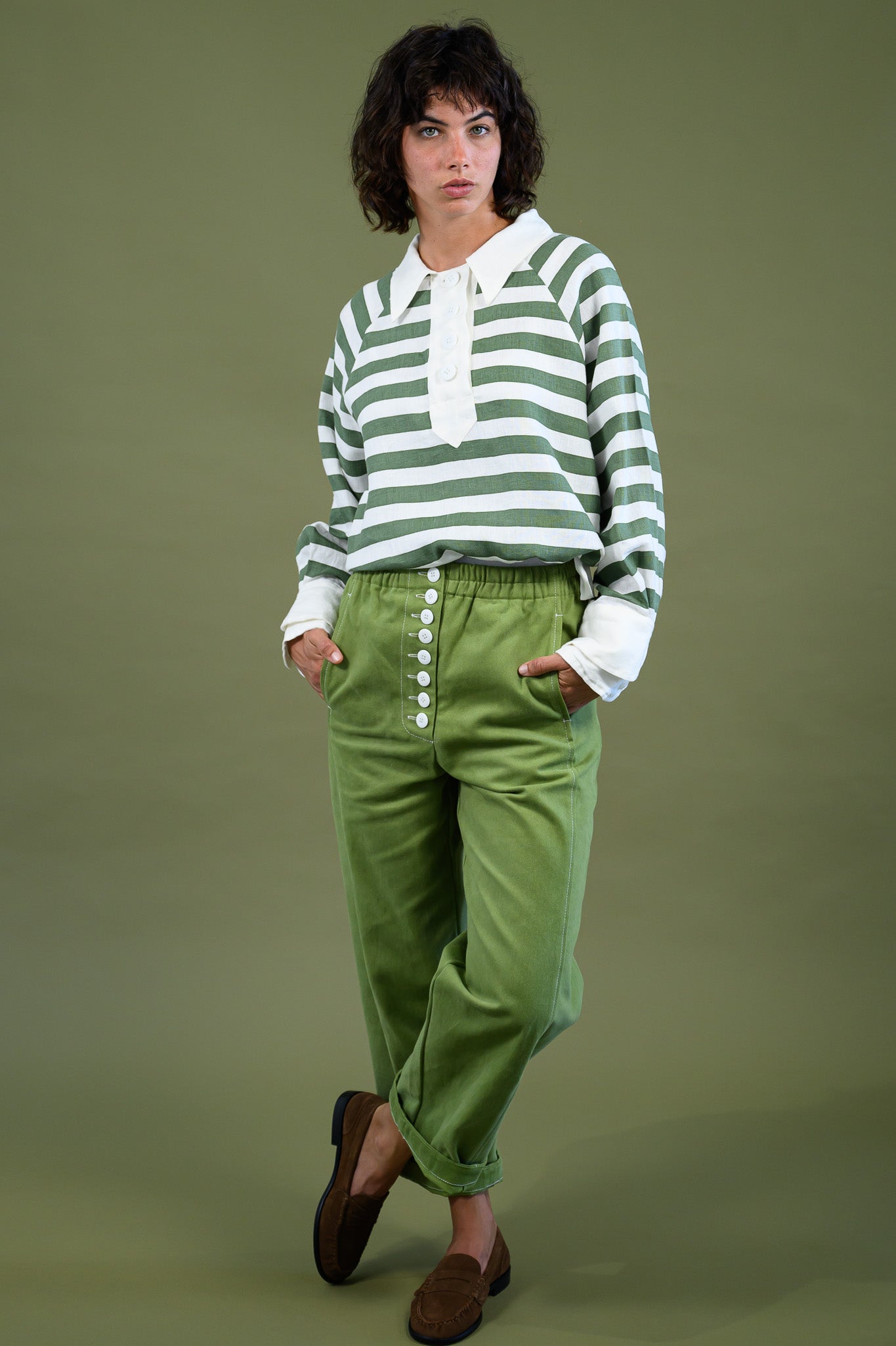 Harrington shirt meadow green stripe linen styled in motion with green pants showing relaxed fit and natural movement