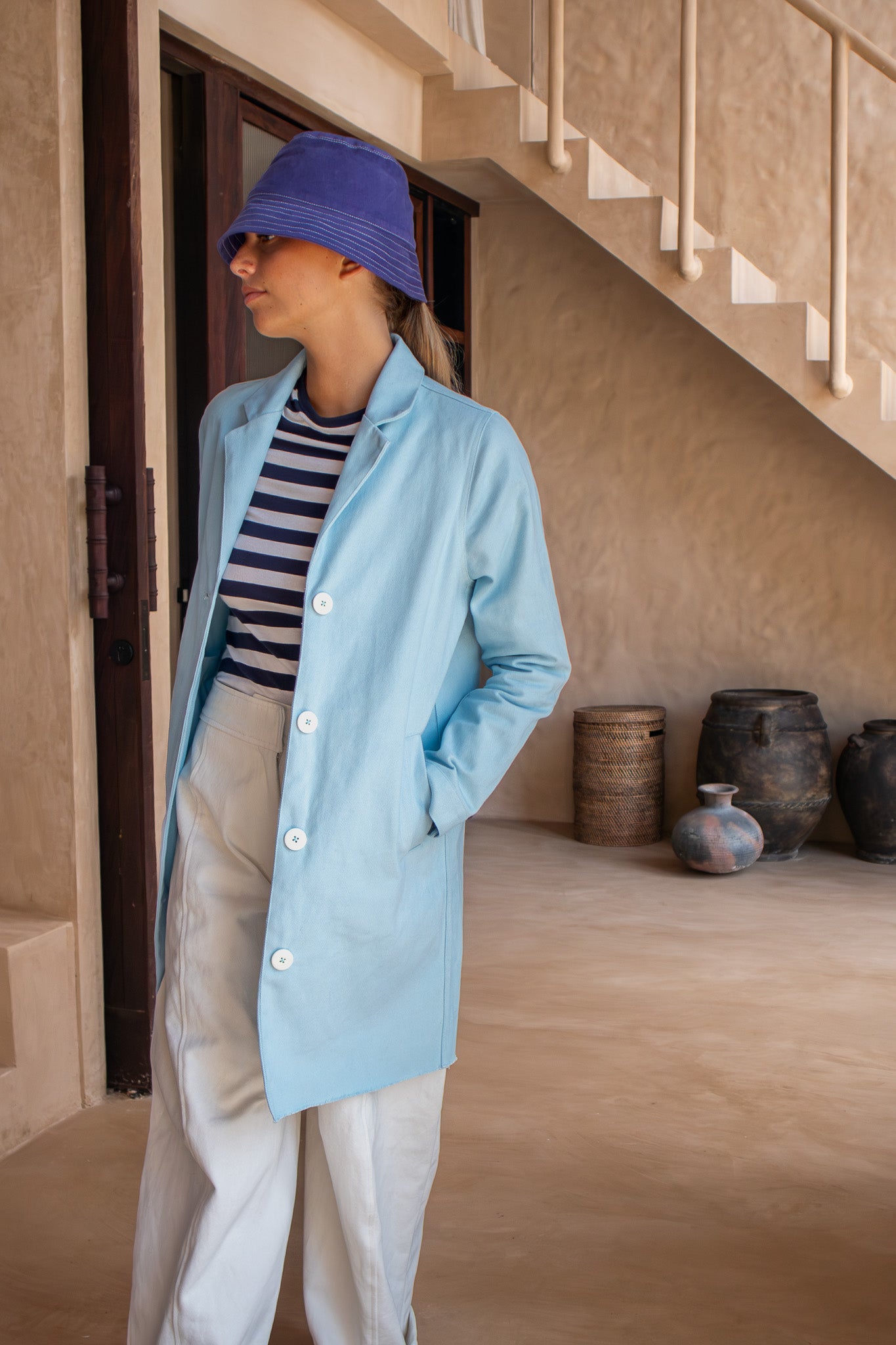 Close-up front view of the Hunter Coat in Light Sky Blue cotton twill suede showing large white buttons.
