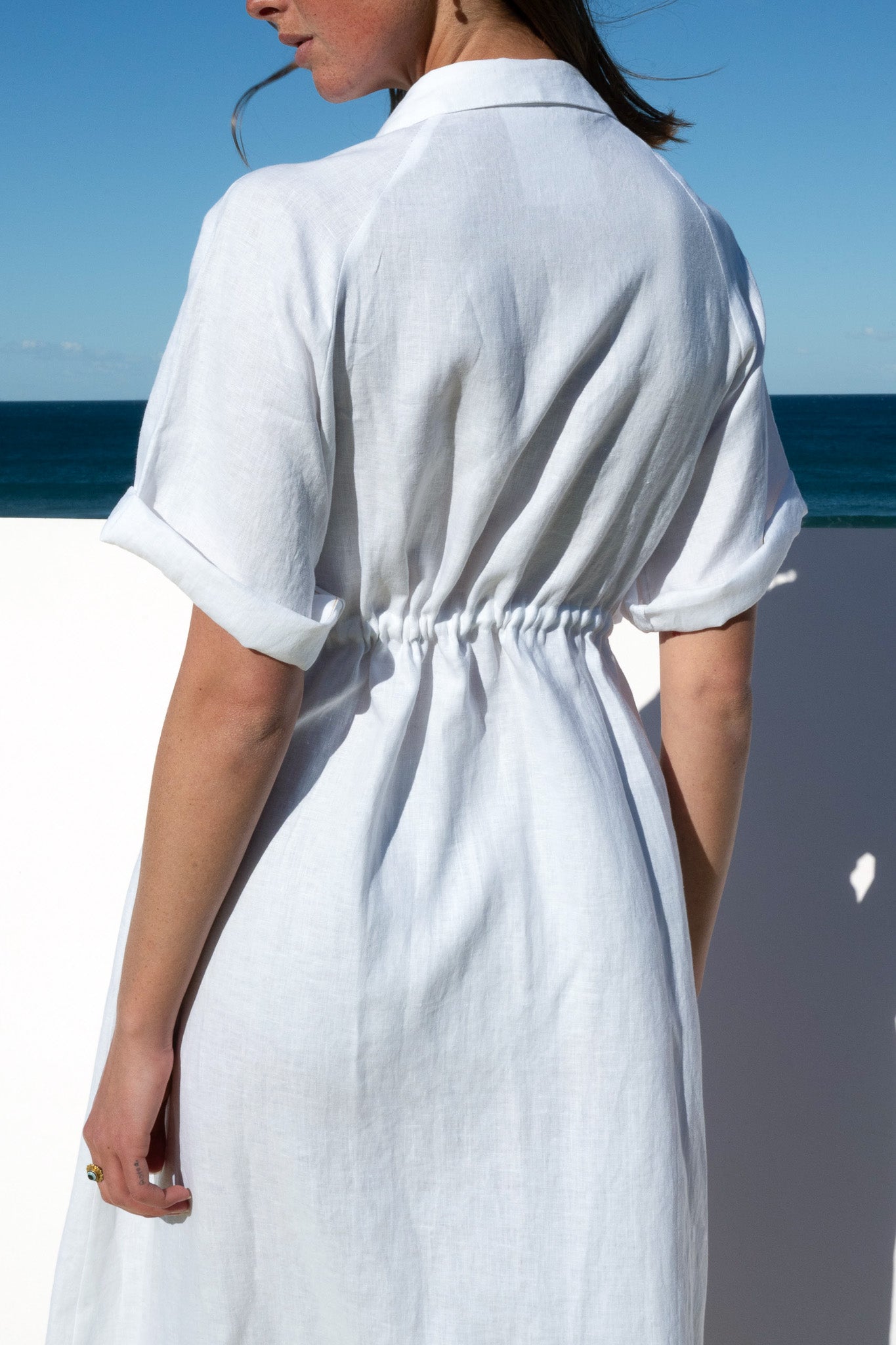 White Iconica Dress with yellow zip – back view with relaxed fit and drawstring waist