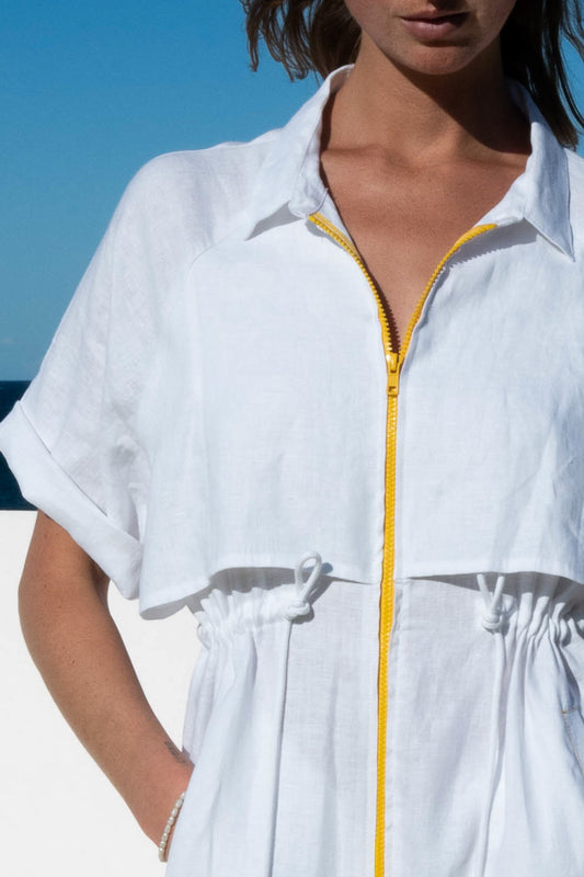 White Iconica Dress with yellow zip – close-up of front zipper and overlay detail