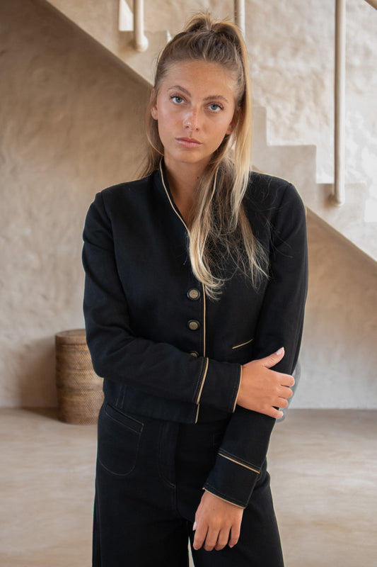 Celine Jacket in organic black denim with brass buttons and gold piping – front view of tailored silhouette"