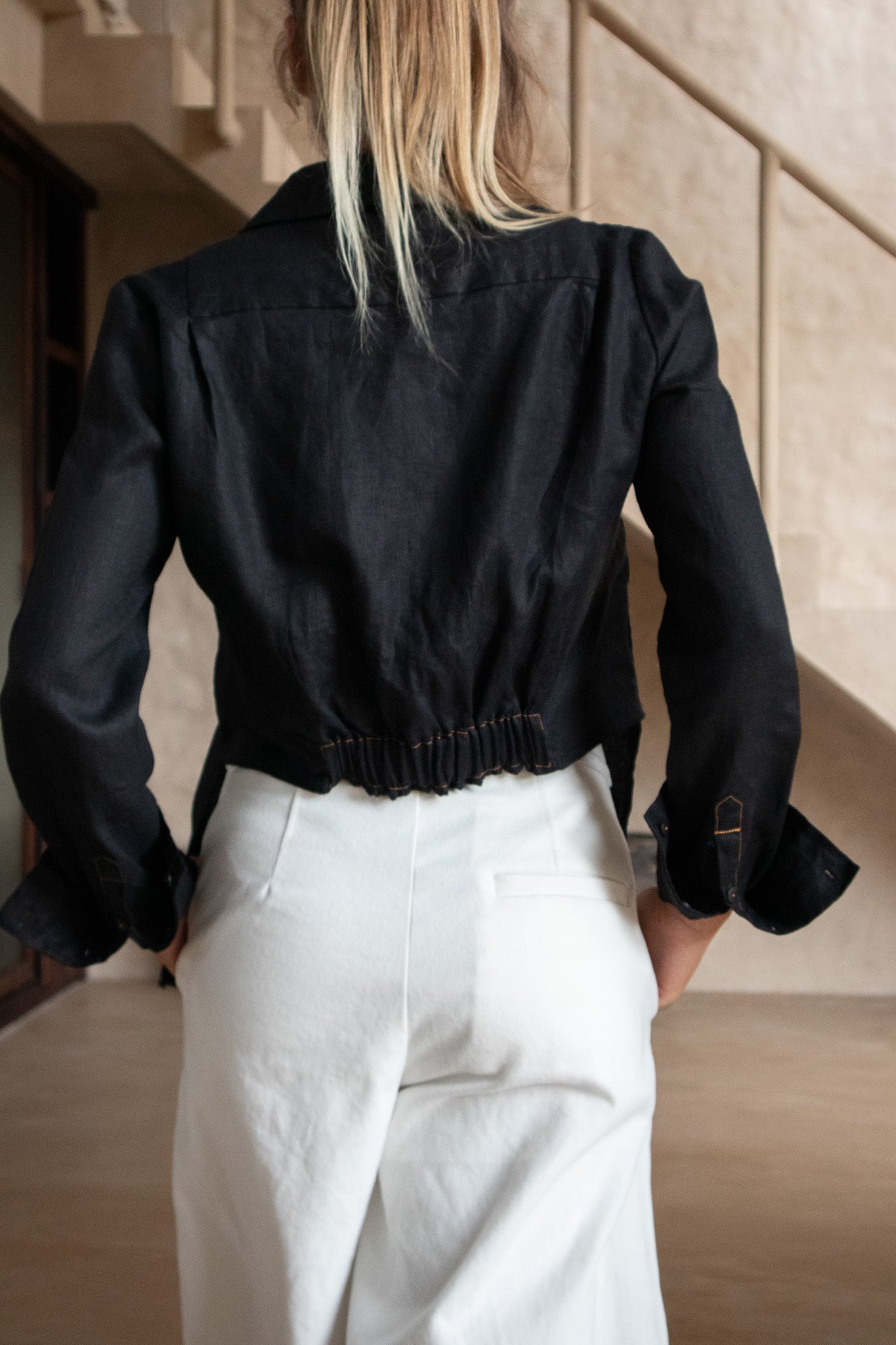 Back view of GiGi shirt in premium black linen with gathered waistband – comfort meets craftsmanship