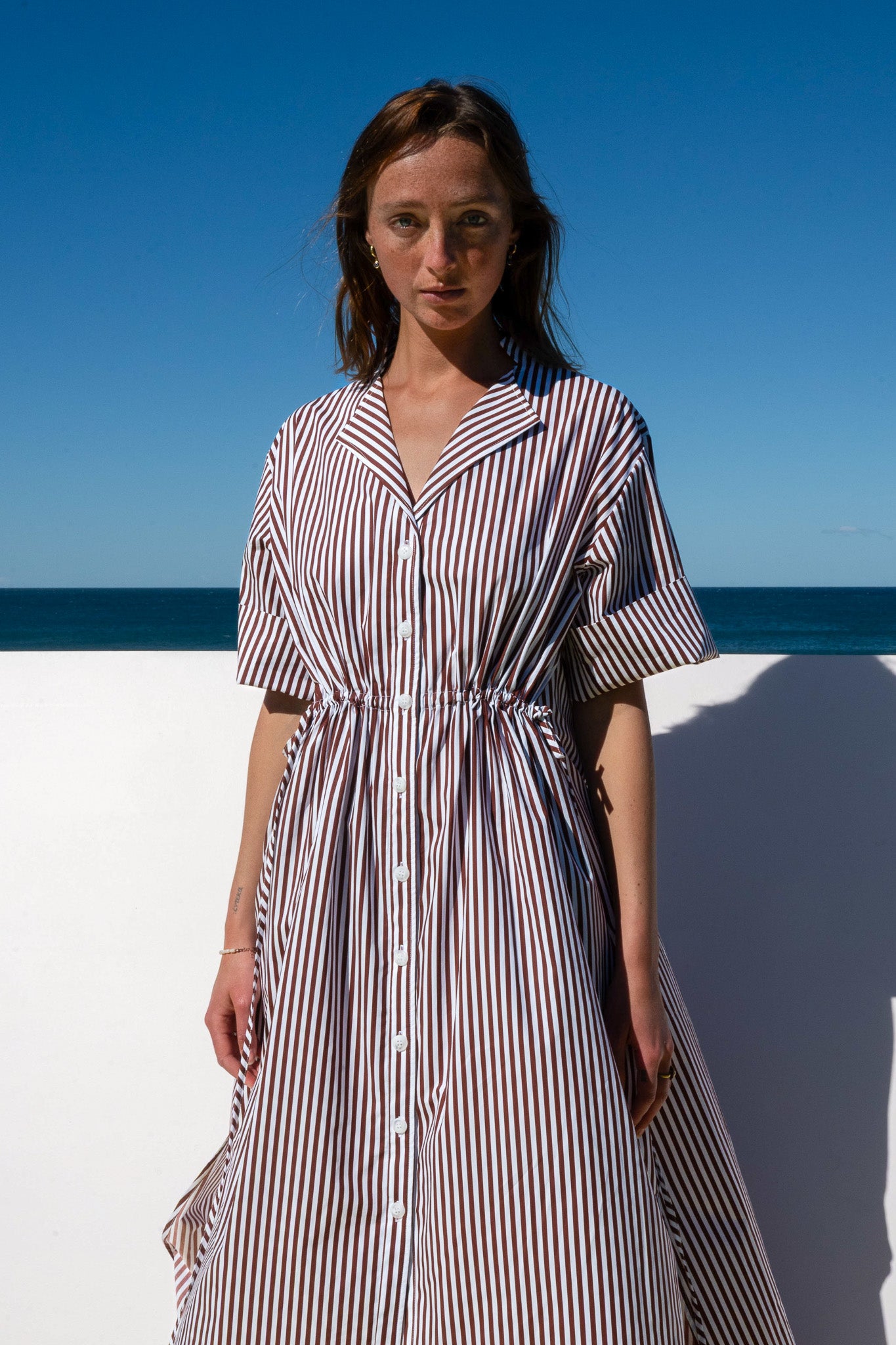 Close-up of The Boy & I Leon Dress in espresso stripe featuring button-down placket and cinched waist.