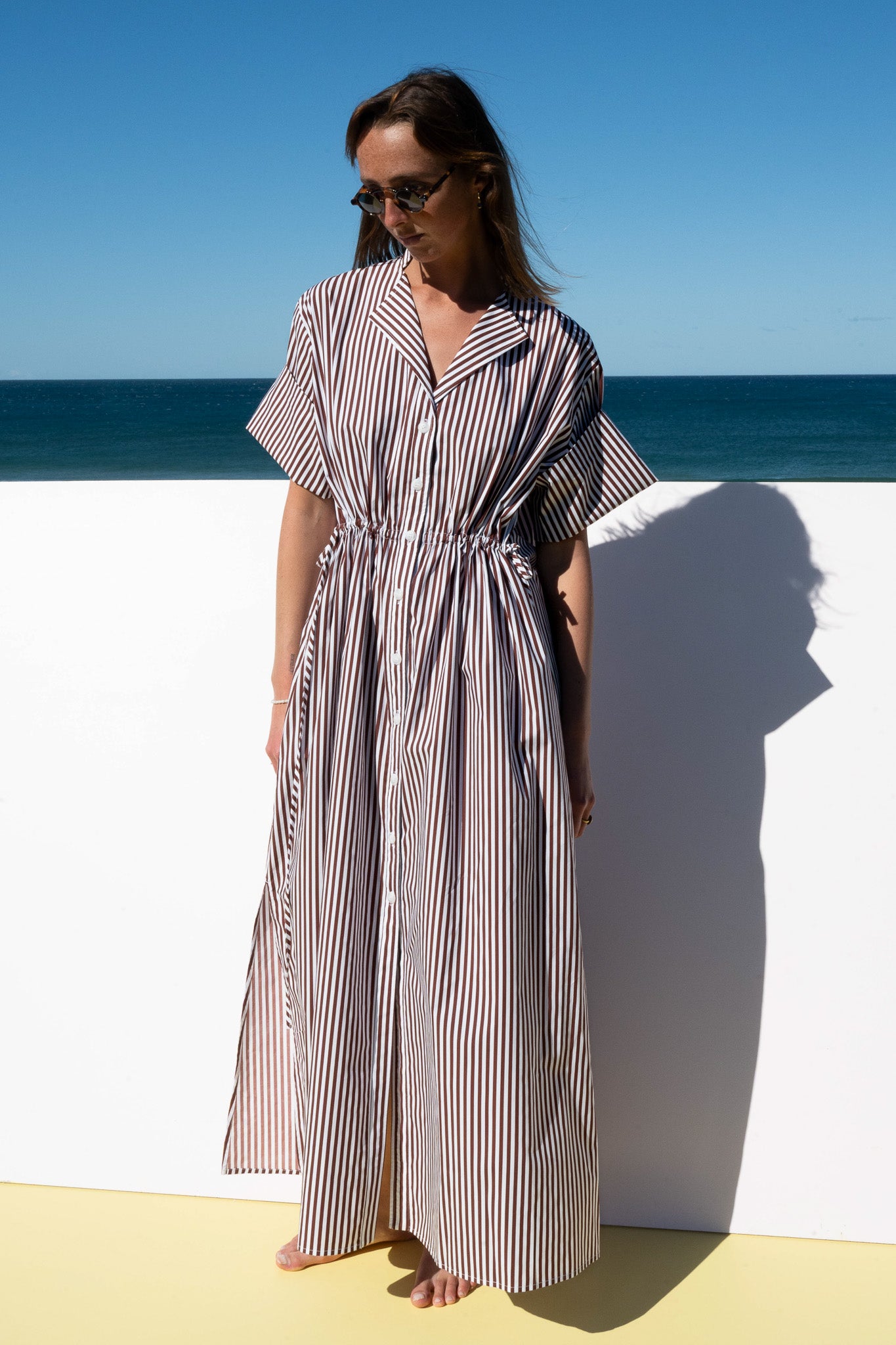 Full-length view of The Boy & I Leon Dress in espresso stripe, styled with short sleeves and side pockets.