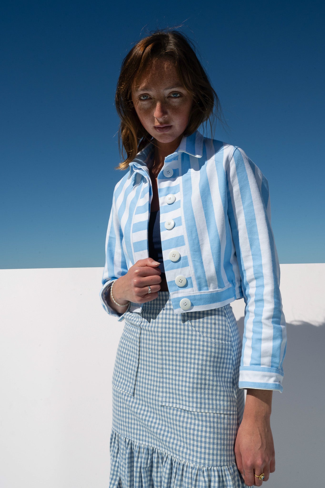 Angled close-up of Mon Petit Jacket Saltwater Stripe showing cropped silhouette and wide collar.