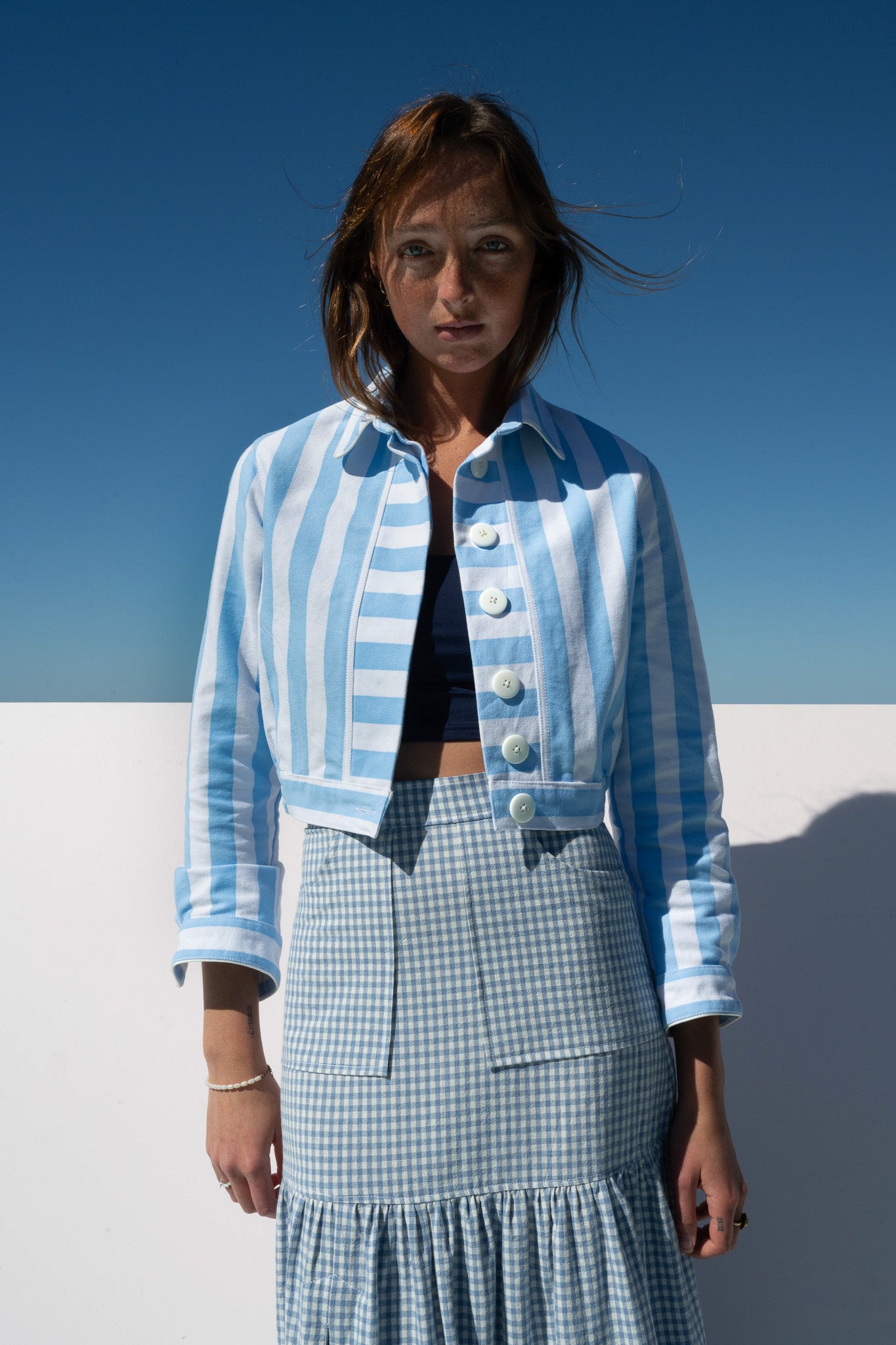 Front-facing view of Mon Petit Jacket Saltwater Stripe styled with gingham skirt, oversized buttons visible.
