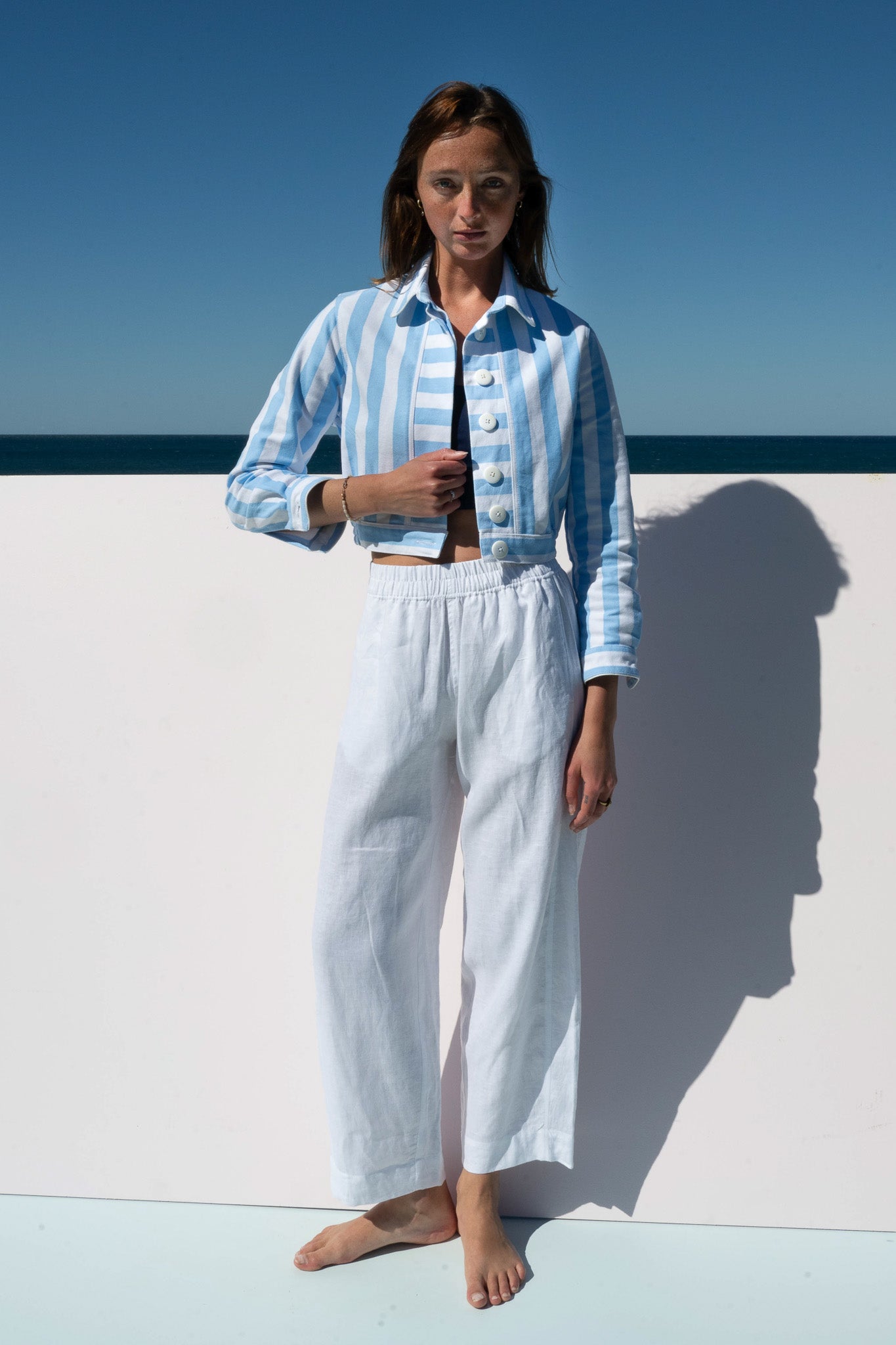 Front view of Mon Petit Jacket in Saltwater Stripe paired with relaxed white linen pants.