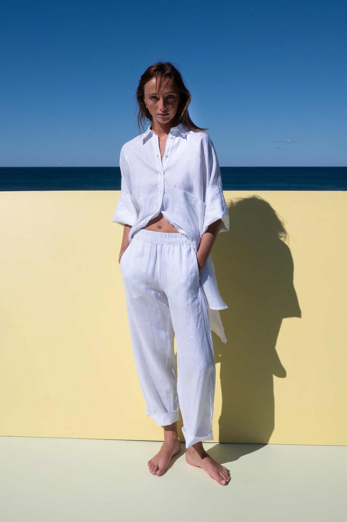 Oceanic Shirt Dress in white linen – styled open at the front with matching pants