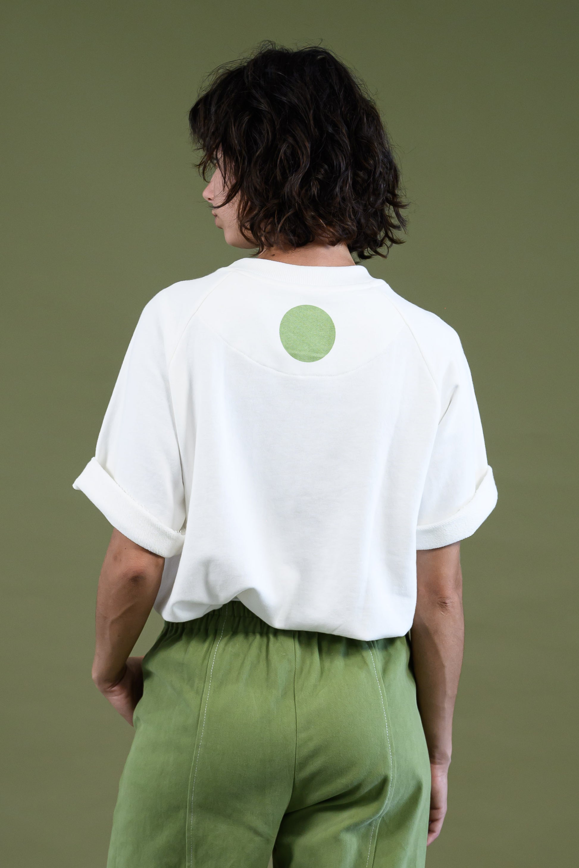 Raglan sleeve sweatshirt with the model showing the back detail of the dot 