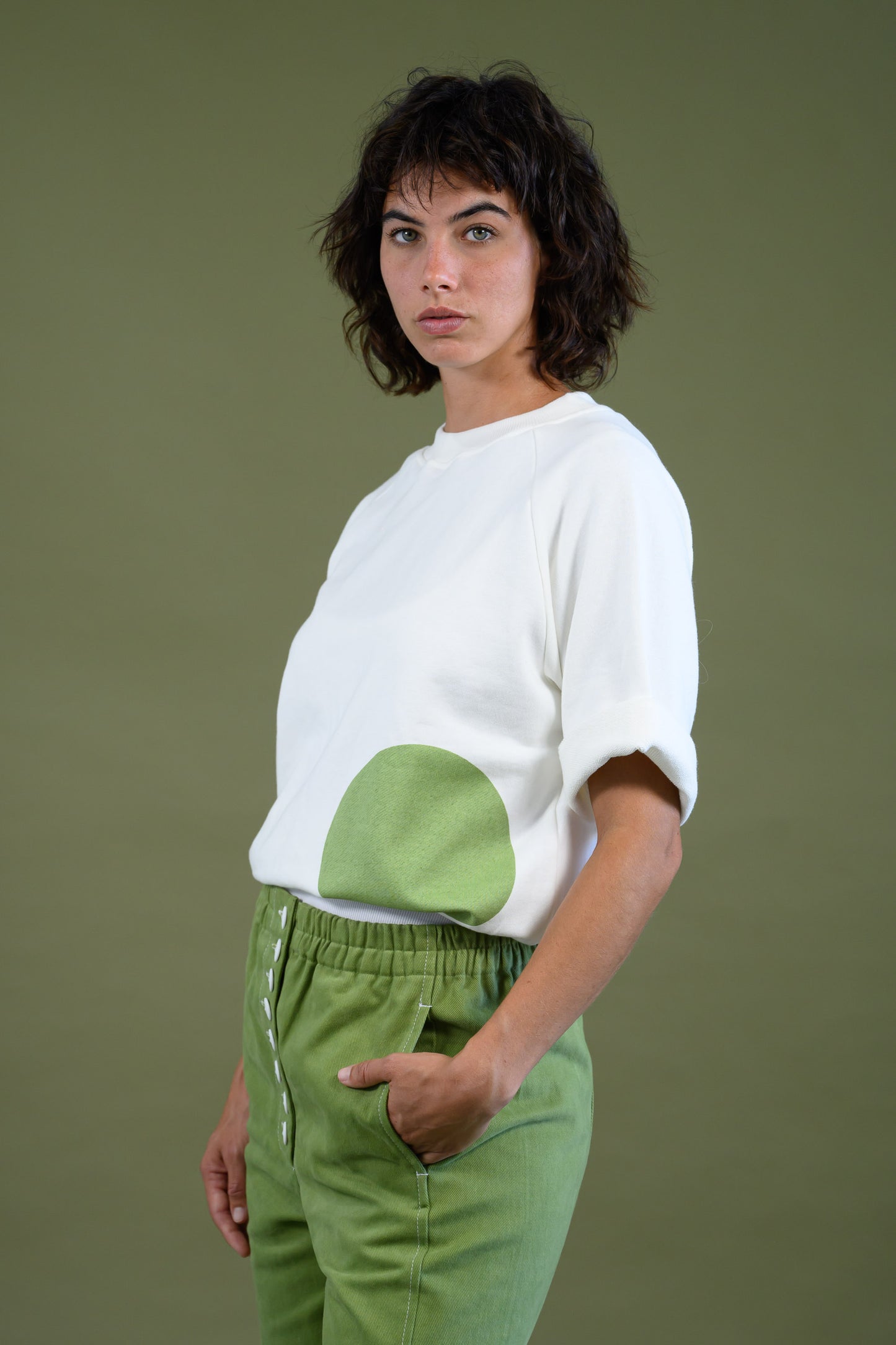 Womens white raglan sleeve cotton sweatshirt with dot detail shown in angled view highlighting design and relaxed fit
