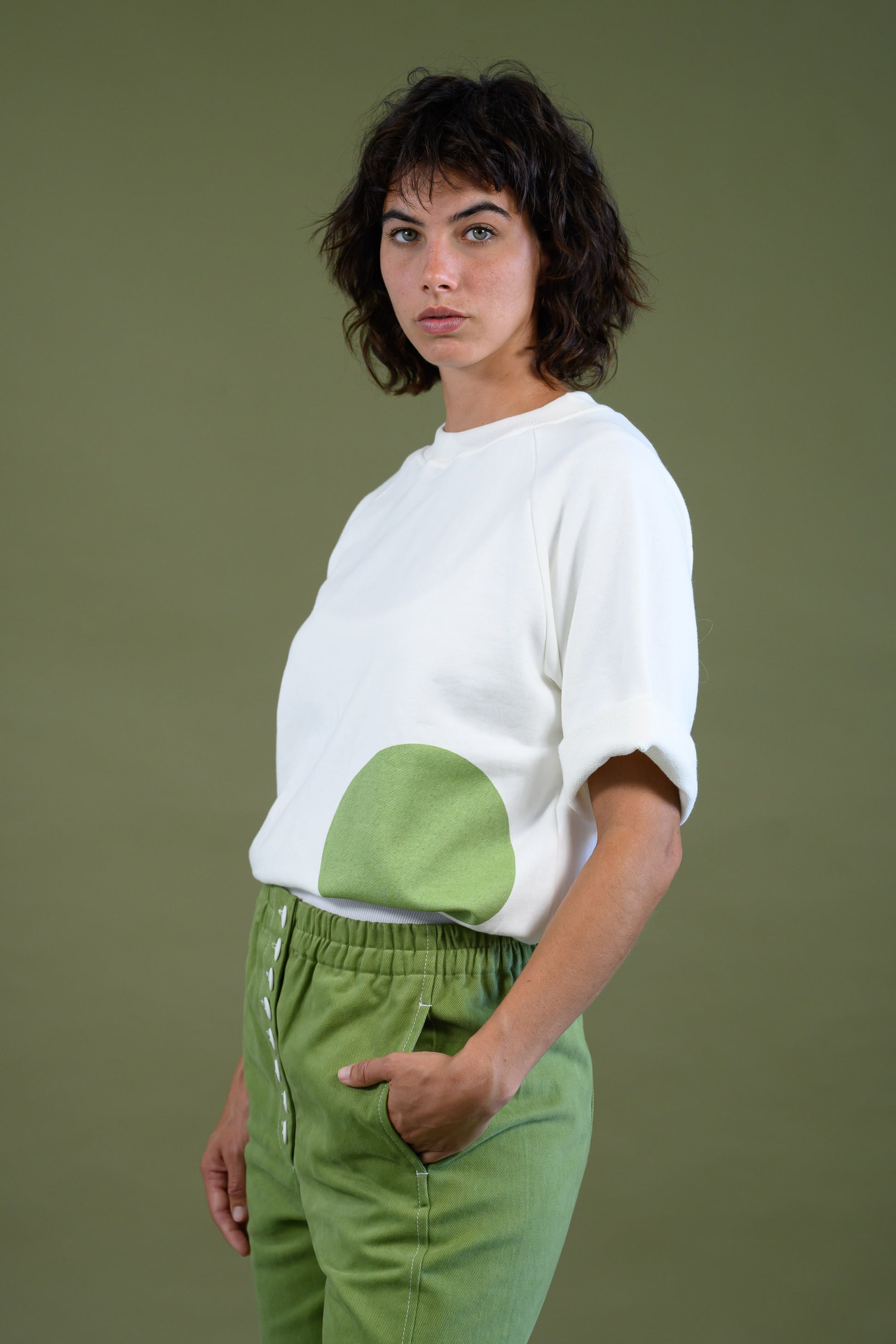 Womens white raglan sleeve cotton sweatshirt with dot detail shown in angled view highlighting design and relaxed fit