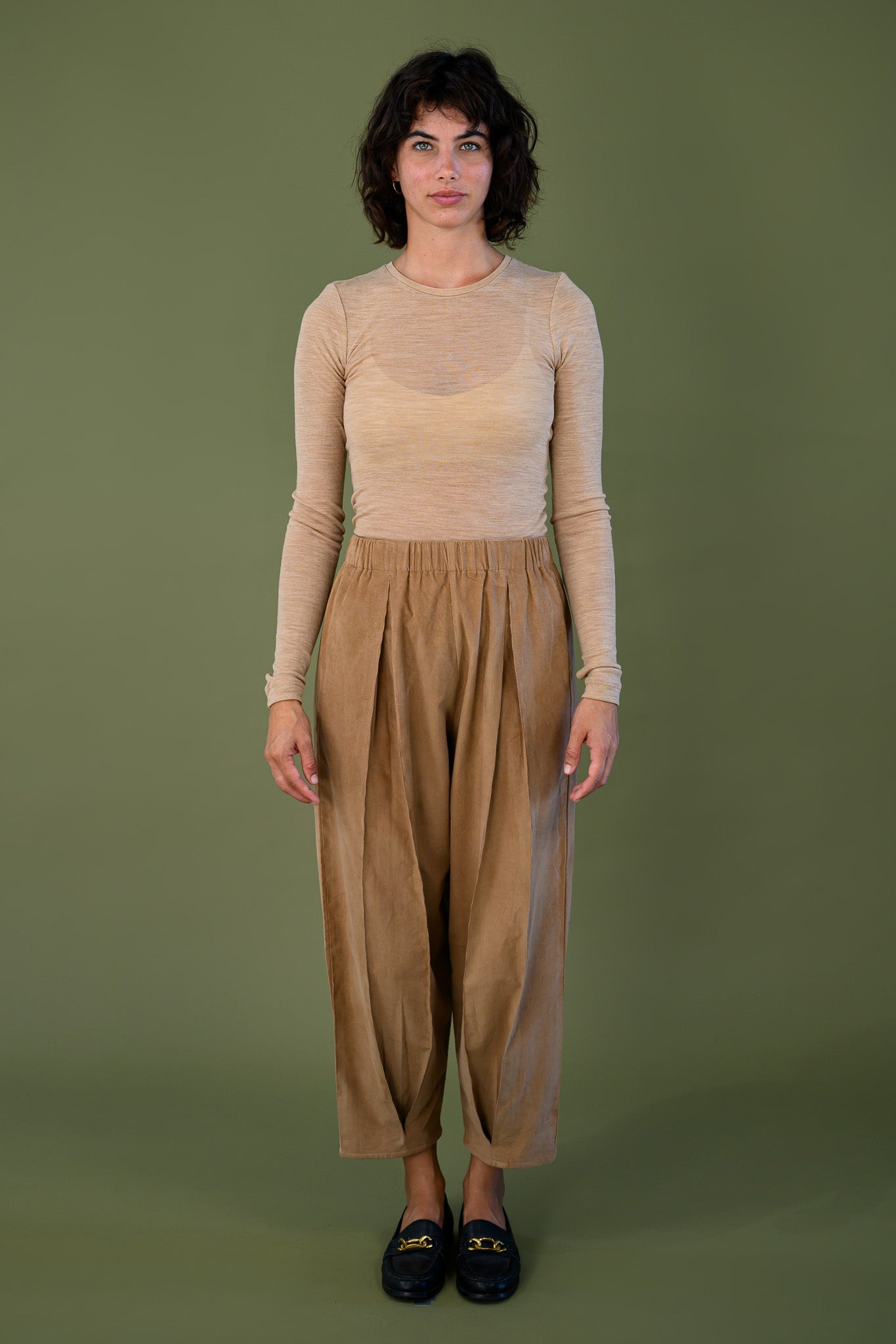 Salt pant in tawny brown cotton corduroy front full length view with neutral long sleeve top showing relaxed high waist fit