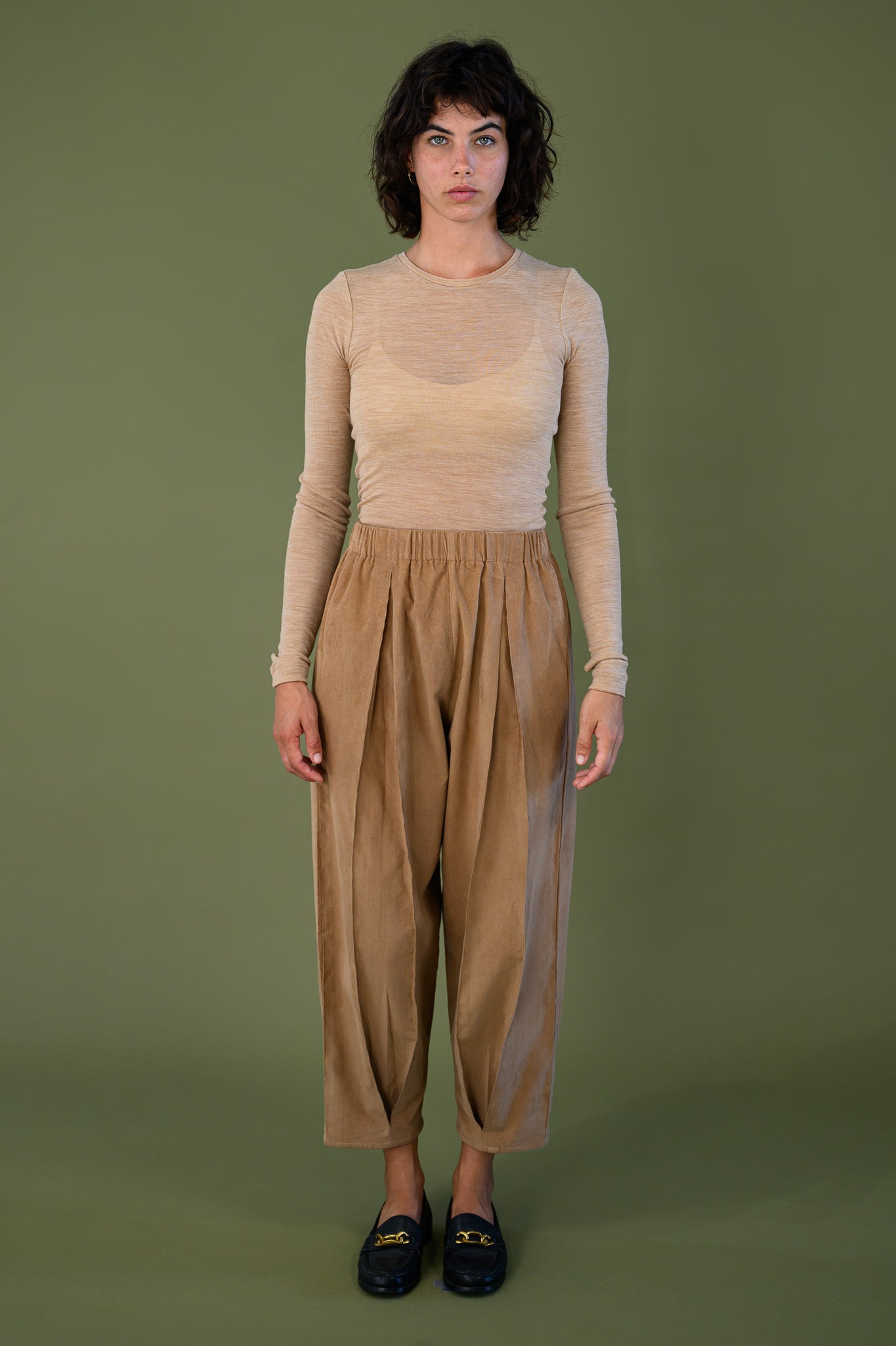 Salt pant in tawny brown cotton corduroy worn full length front view with relaxed fit and tapered leg