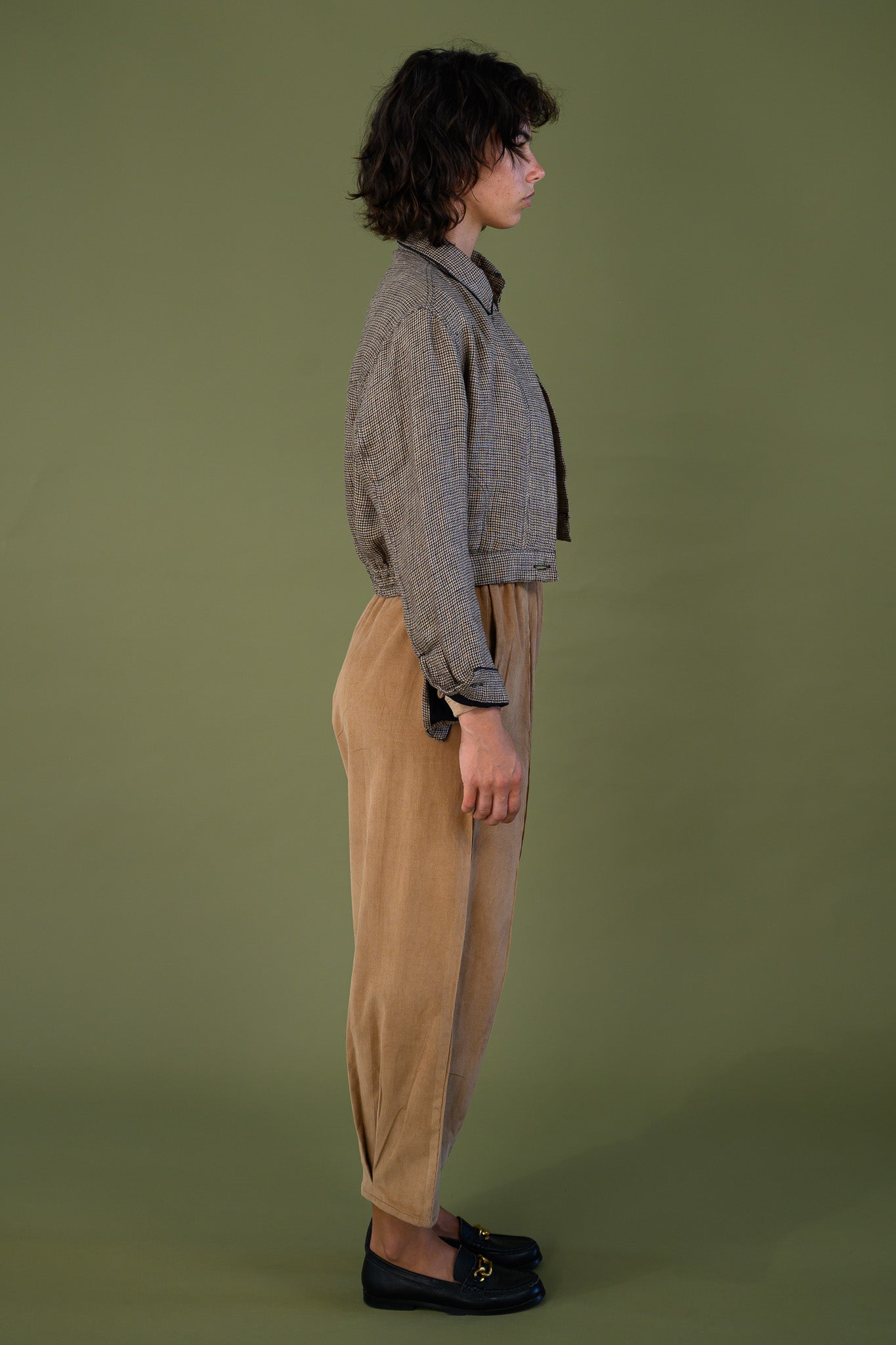 Salt pant in tawny brown cotton corduroy worn full length side profile showing relaxed tapered fit