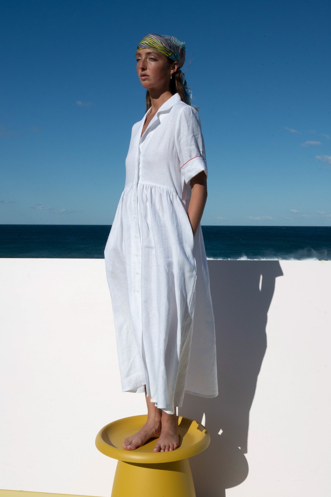 Full-length photo of the Siena Dress in crisp white linen featuring button-down front.