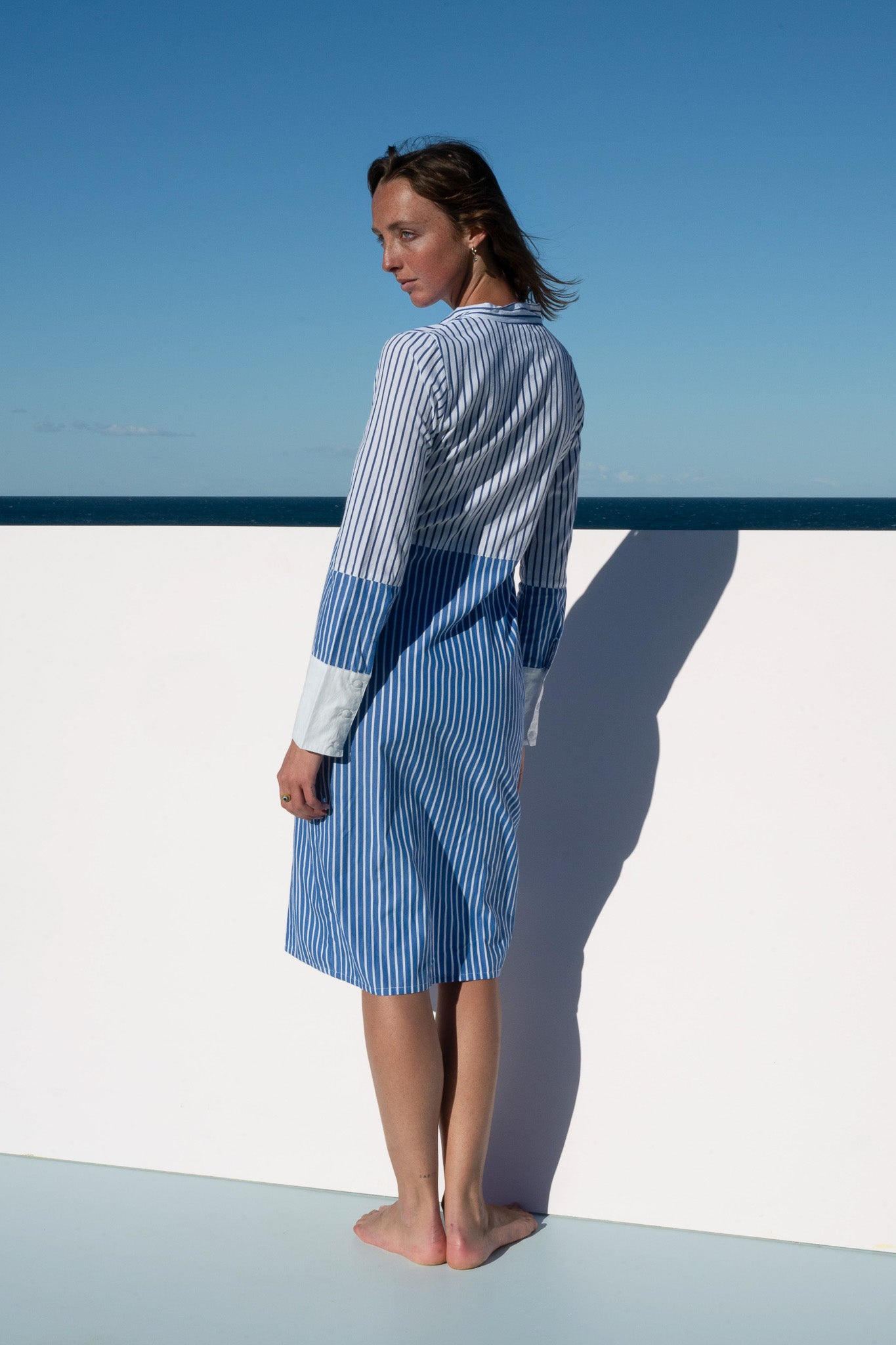Back view of the Sisto Dress in blue and white stripe, tailored shirt-style fit