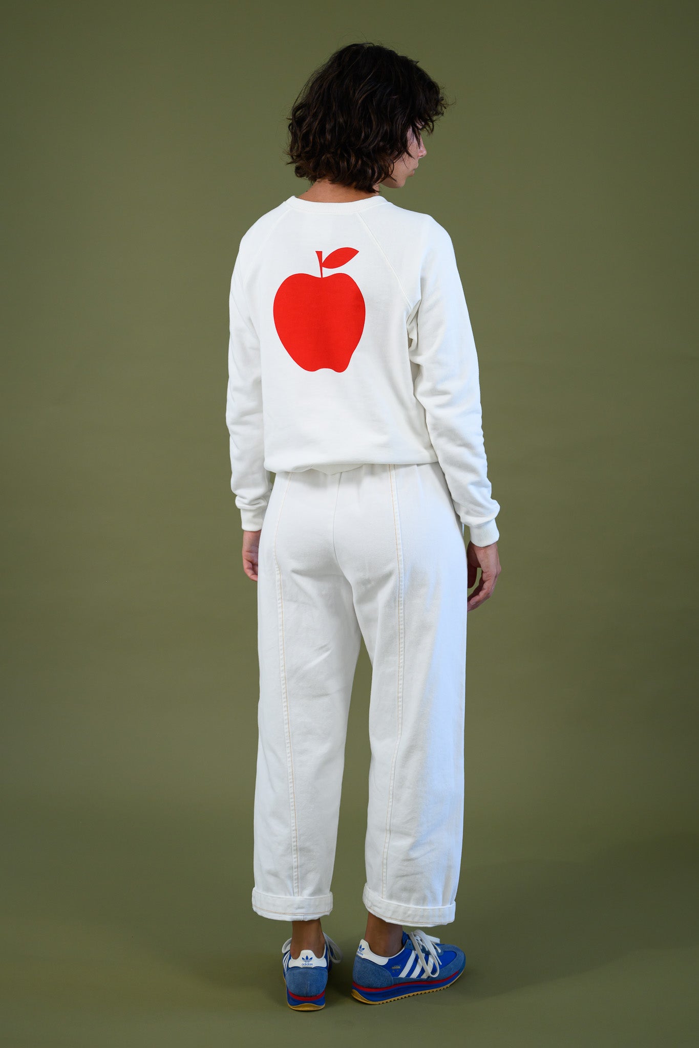 Blaze jogger in white organic cotton twill with a relaxed barrel leg fit shown from the back styled with apple sweatshirt