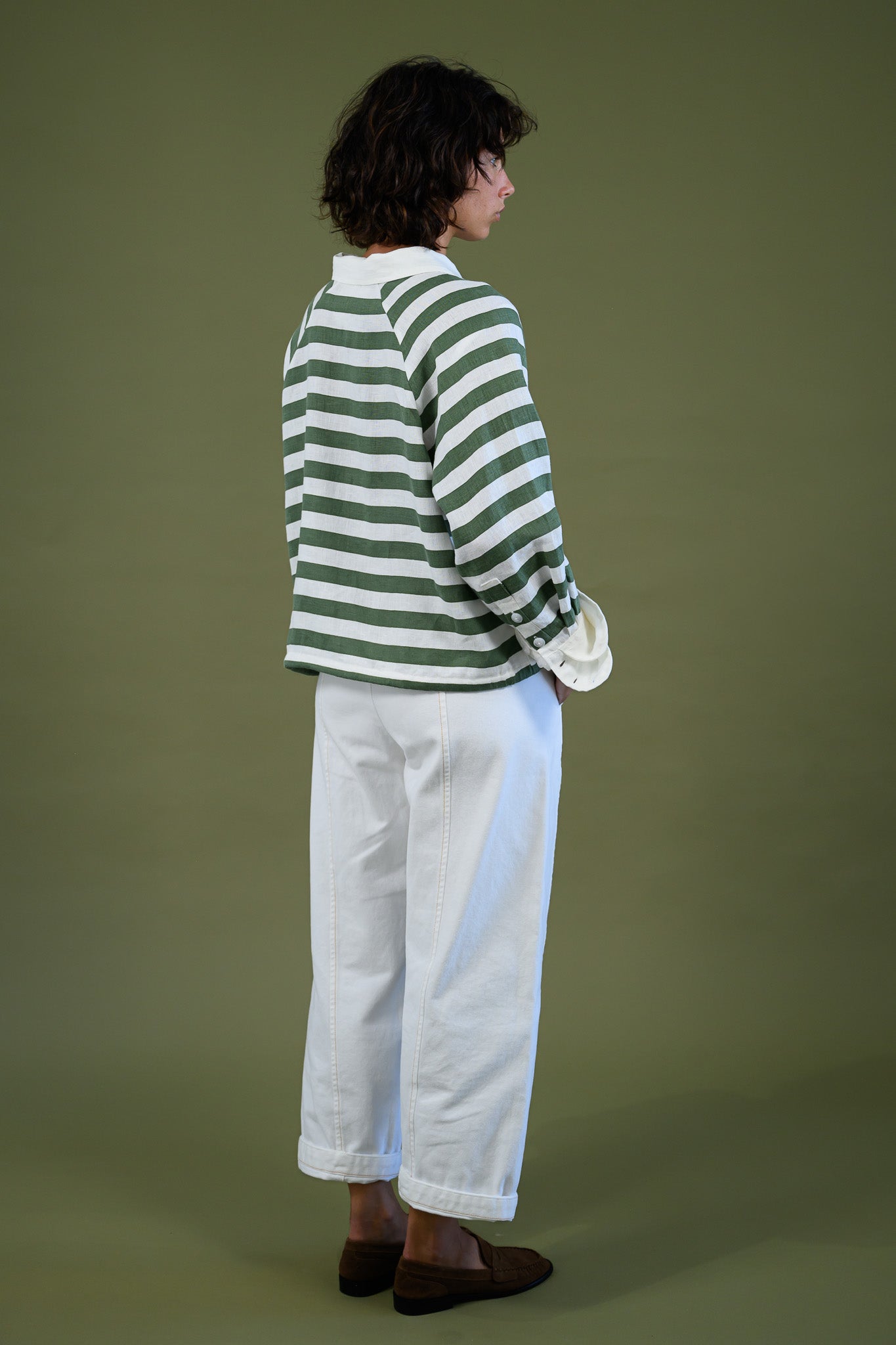 Blaze jogger in white organic cotton twill with a relaxed barrel leg fit shown from the back styled with green stripe rugby top