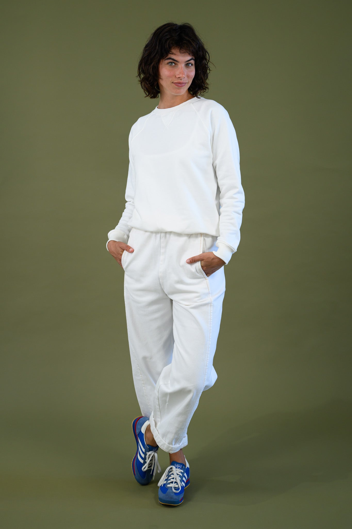 Blaze jogger in white organic cotton twill with a relaxed barrel leg fit styled in a casual walking pose with sneakers