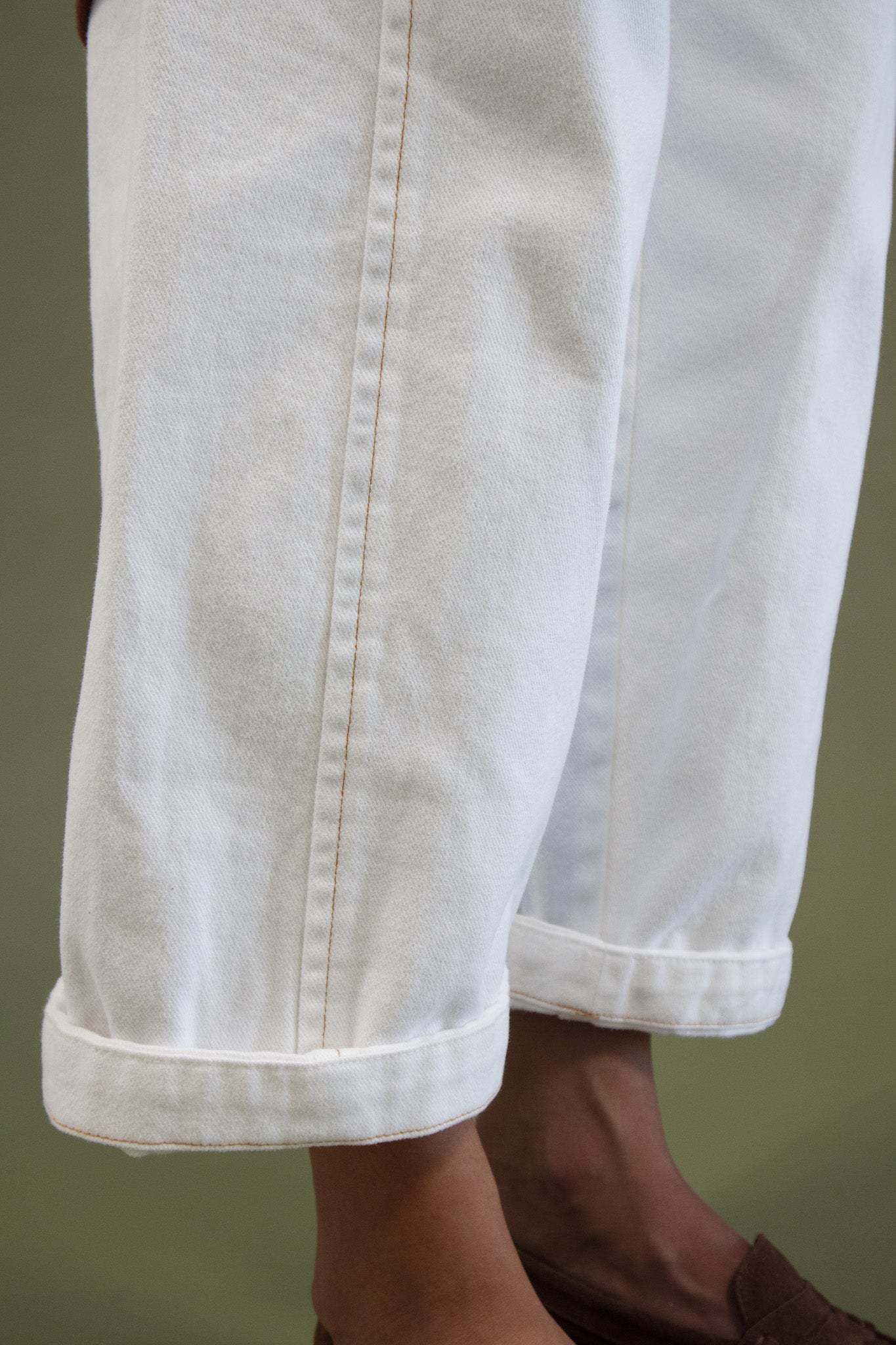 Blaze jogger in white organic cotton twill showing rolled cuff hem and stitching detail