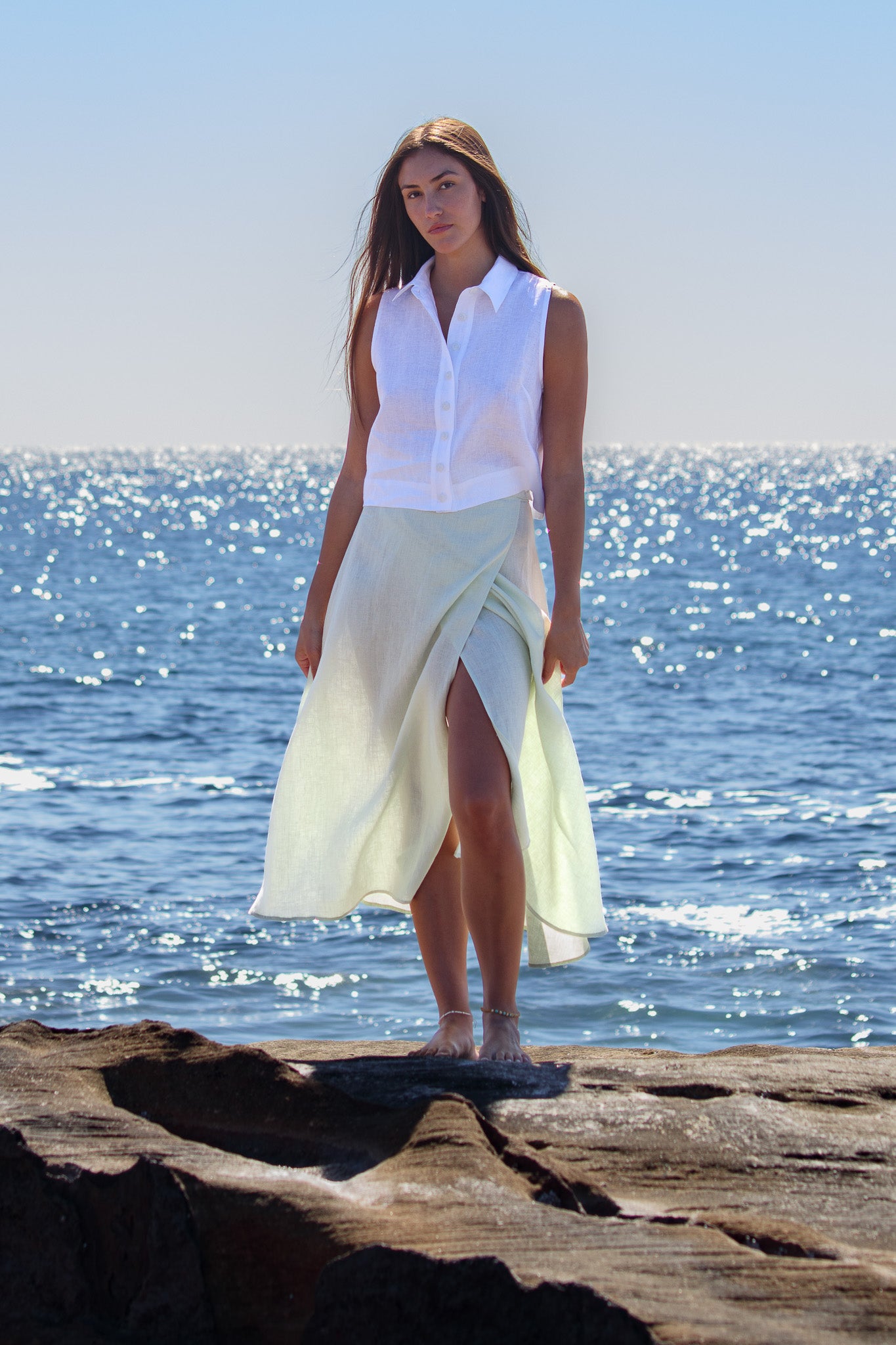 Front view of the Wrap Around Me Skirt in sun washed mint with the wrap front slit showing movement by the ocean.