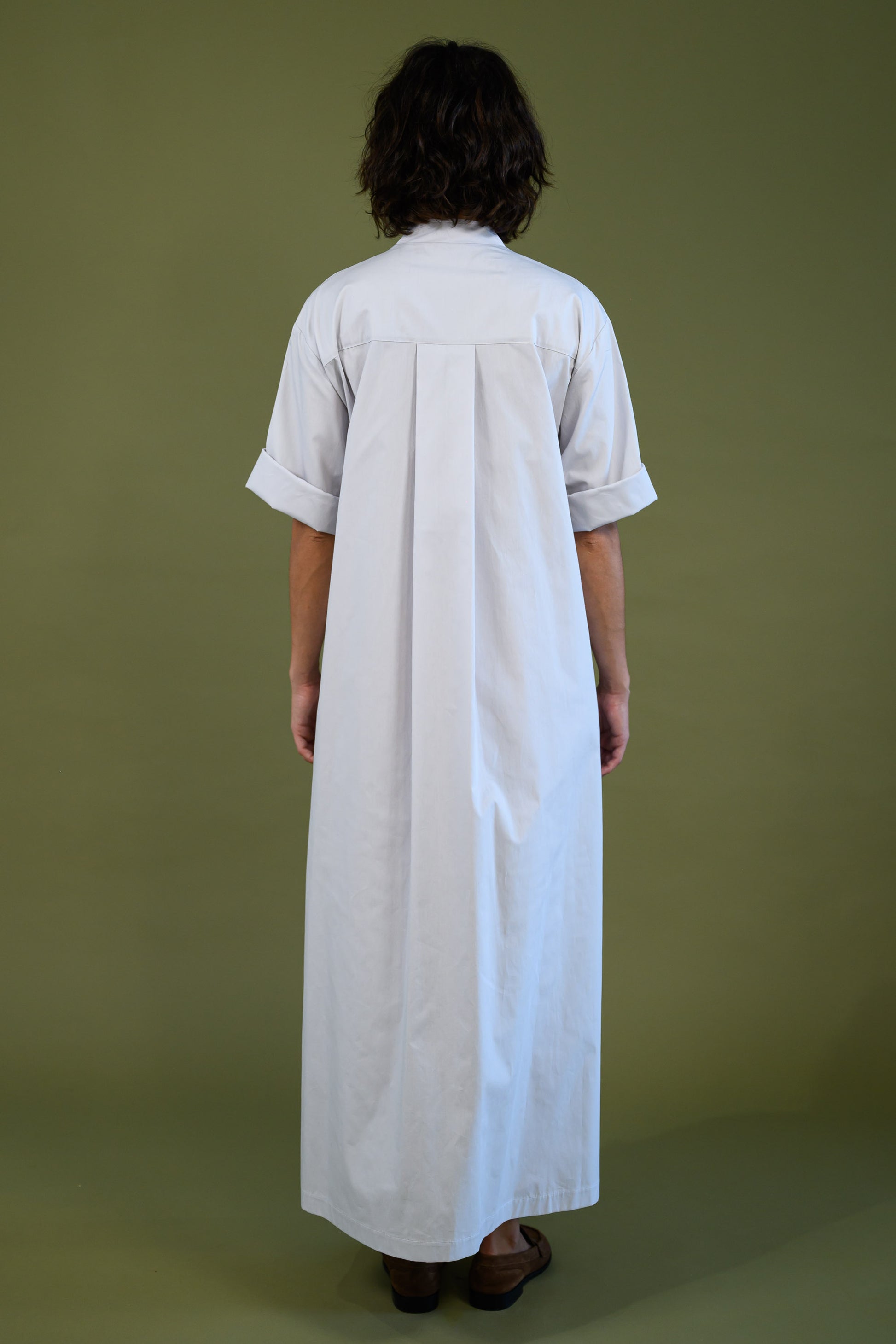 Back view of white cotton poplin dress showing clean structure and fit