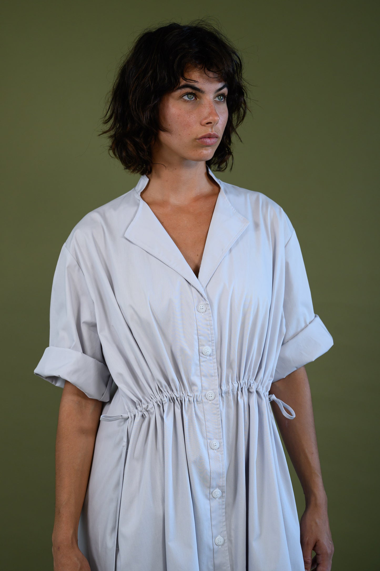 Close up of white cotton poplin dress showing bodice detail and fabric texture