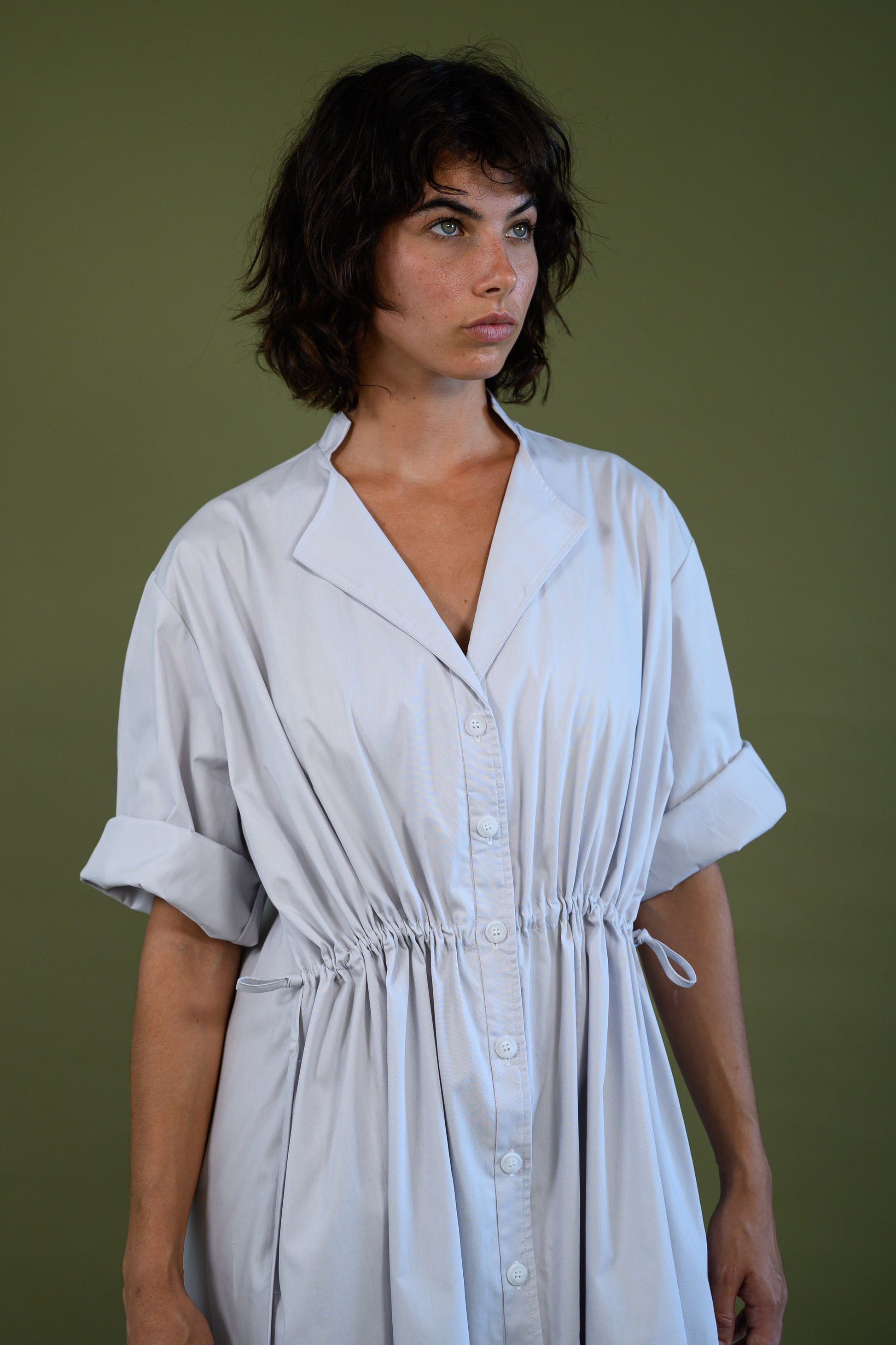 Close up of white cotton poplin dress showing bodice detail and fabric texture