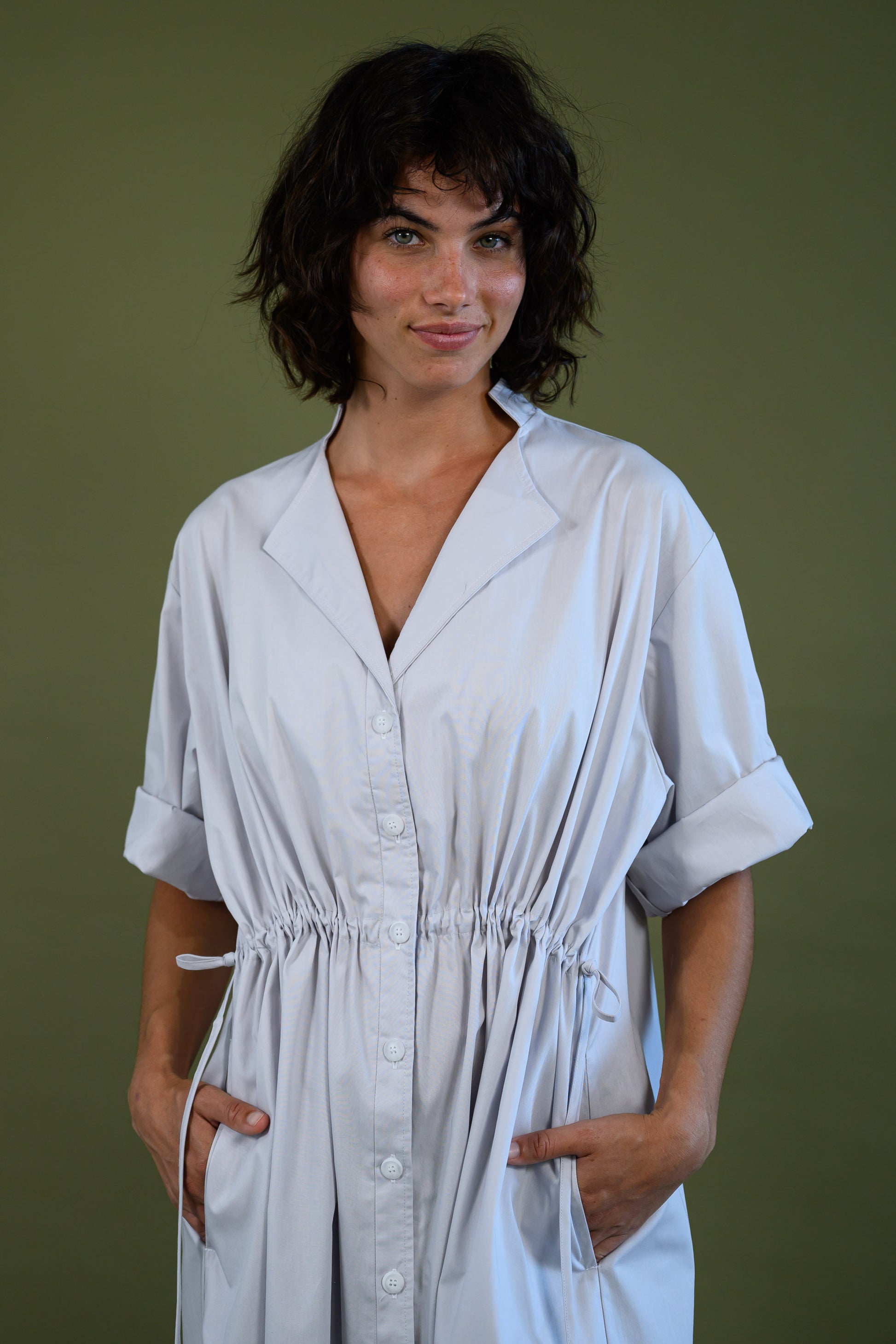 Front detail of white cotton poplin dress showing neckline and stitching