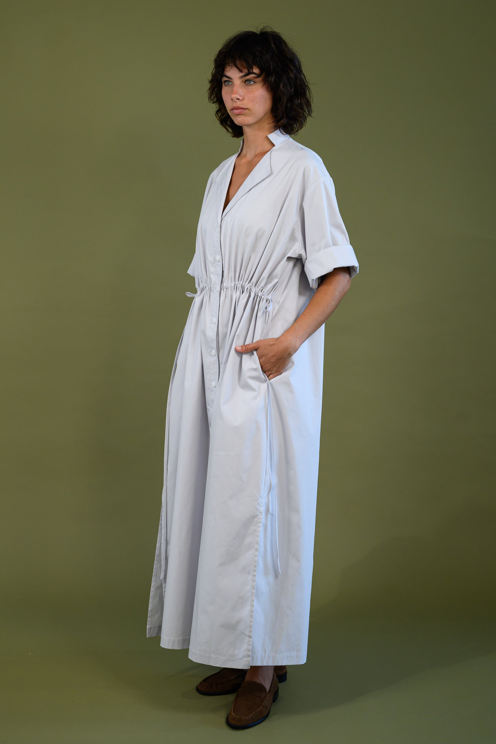 White cotton poplin dress shown from an angled side view with relaxed fit