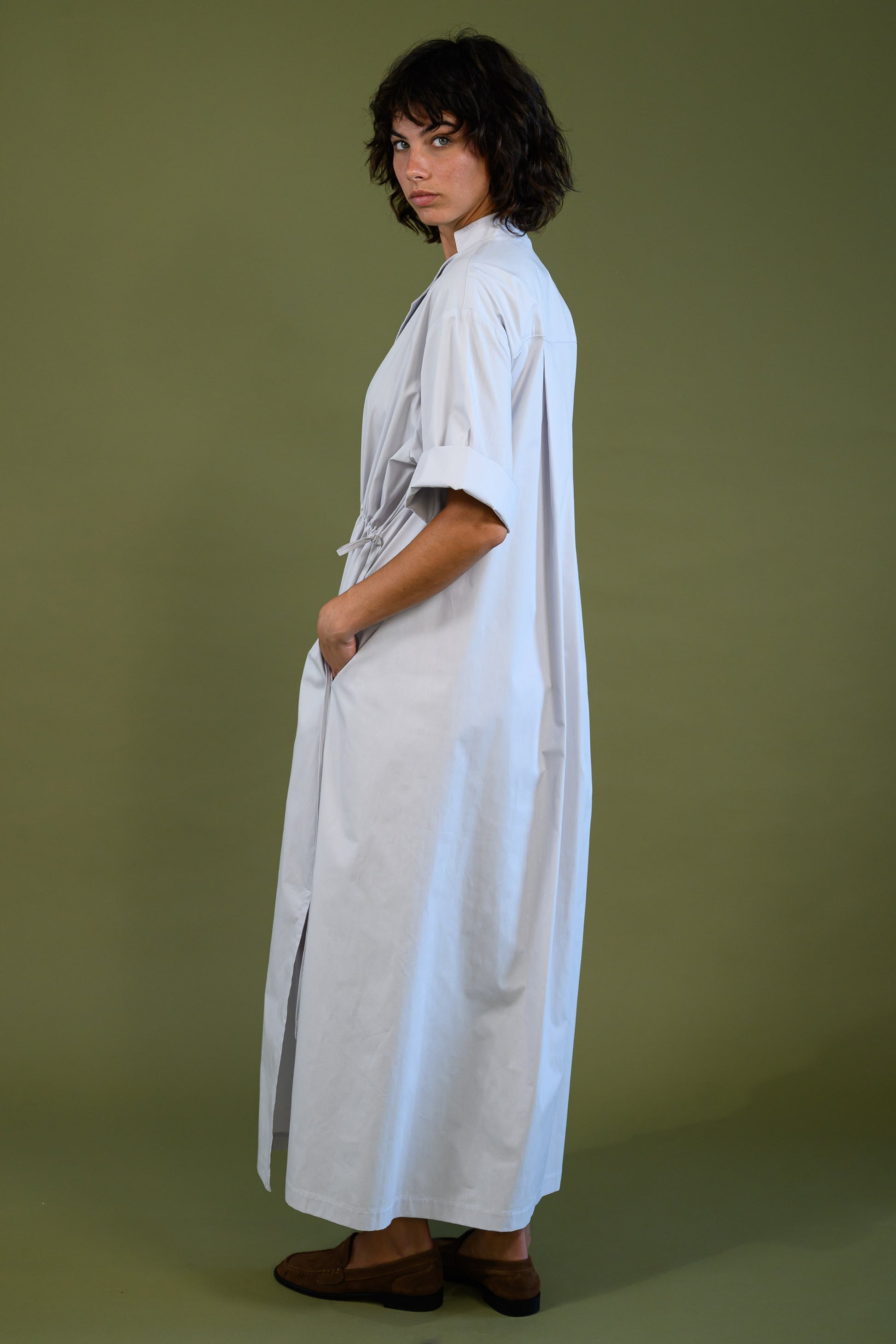 Side view of white cotton poplin dress showing relaxed silhouette