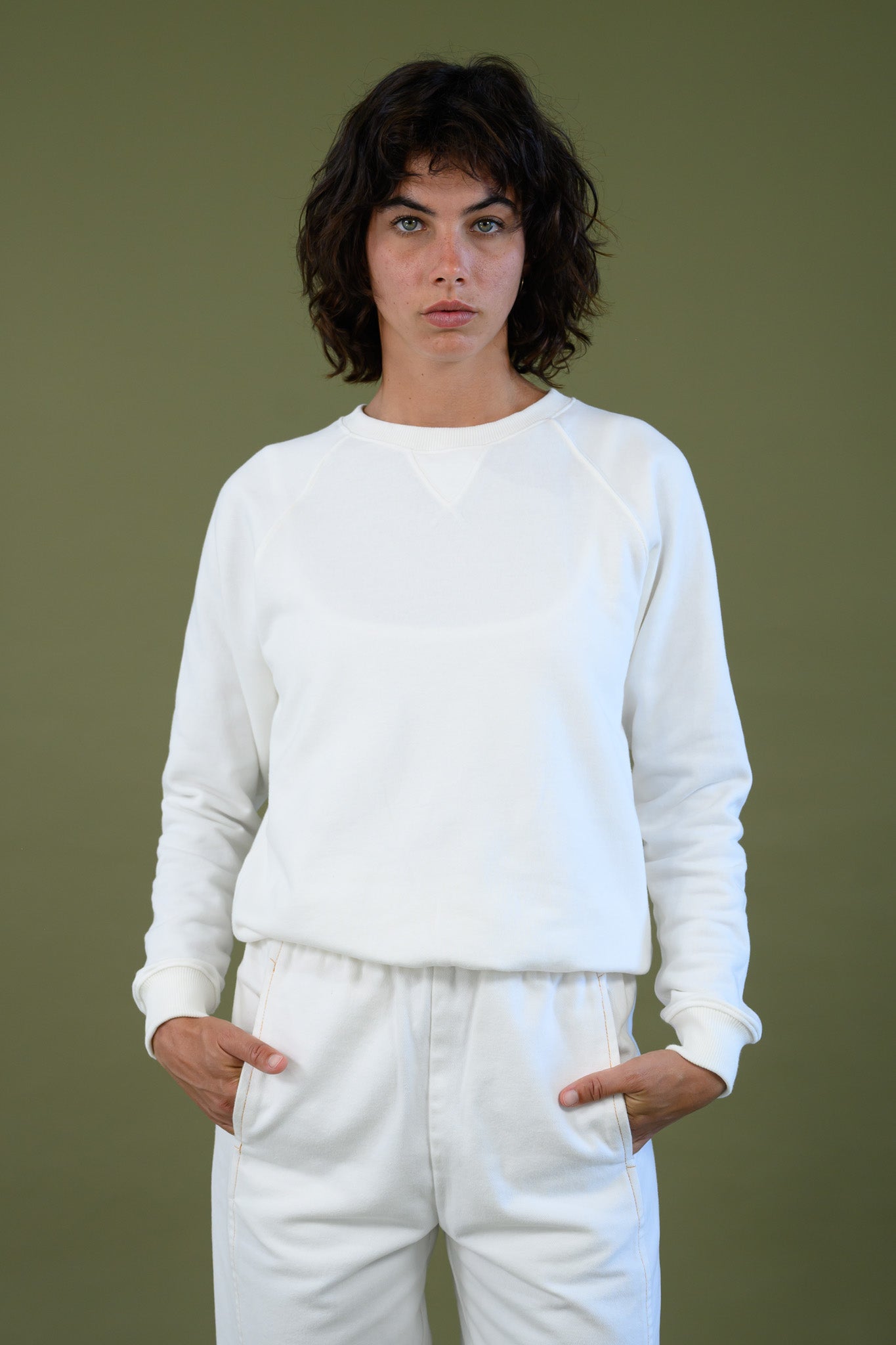 Front view of white cotton sweatshirt showing neckline and ribbed detailing