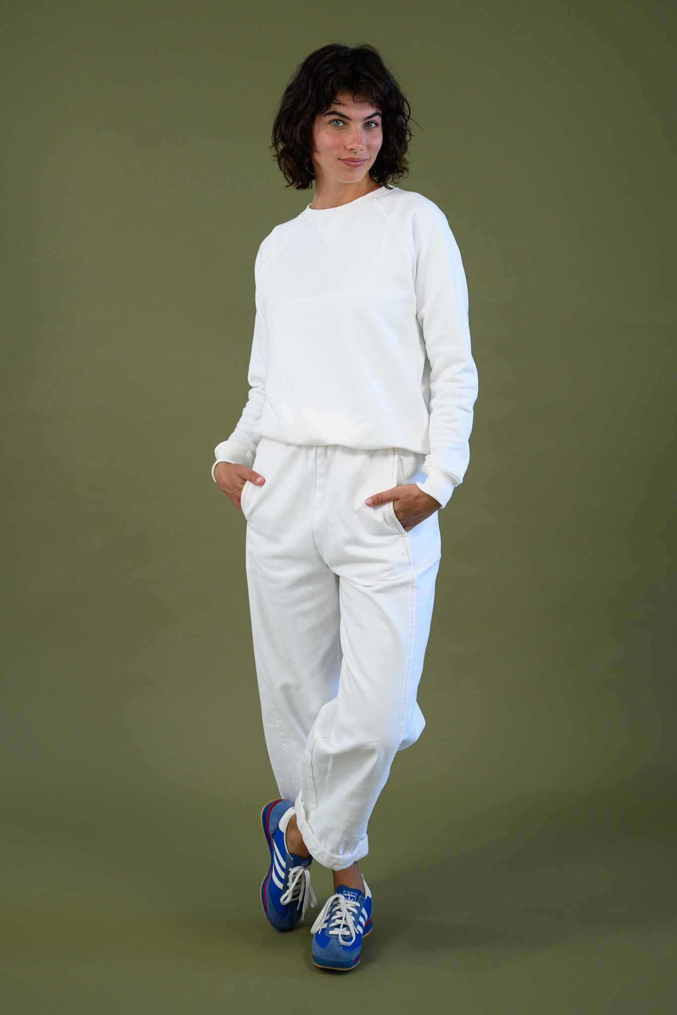 White cotton sweatshirt styled with matching pants shown full length on model