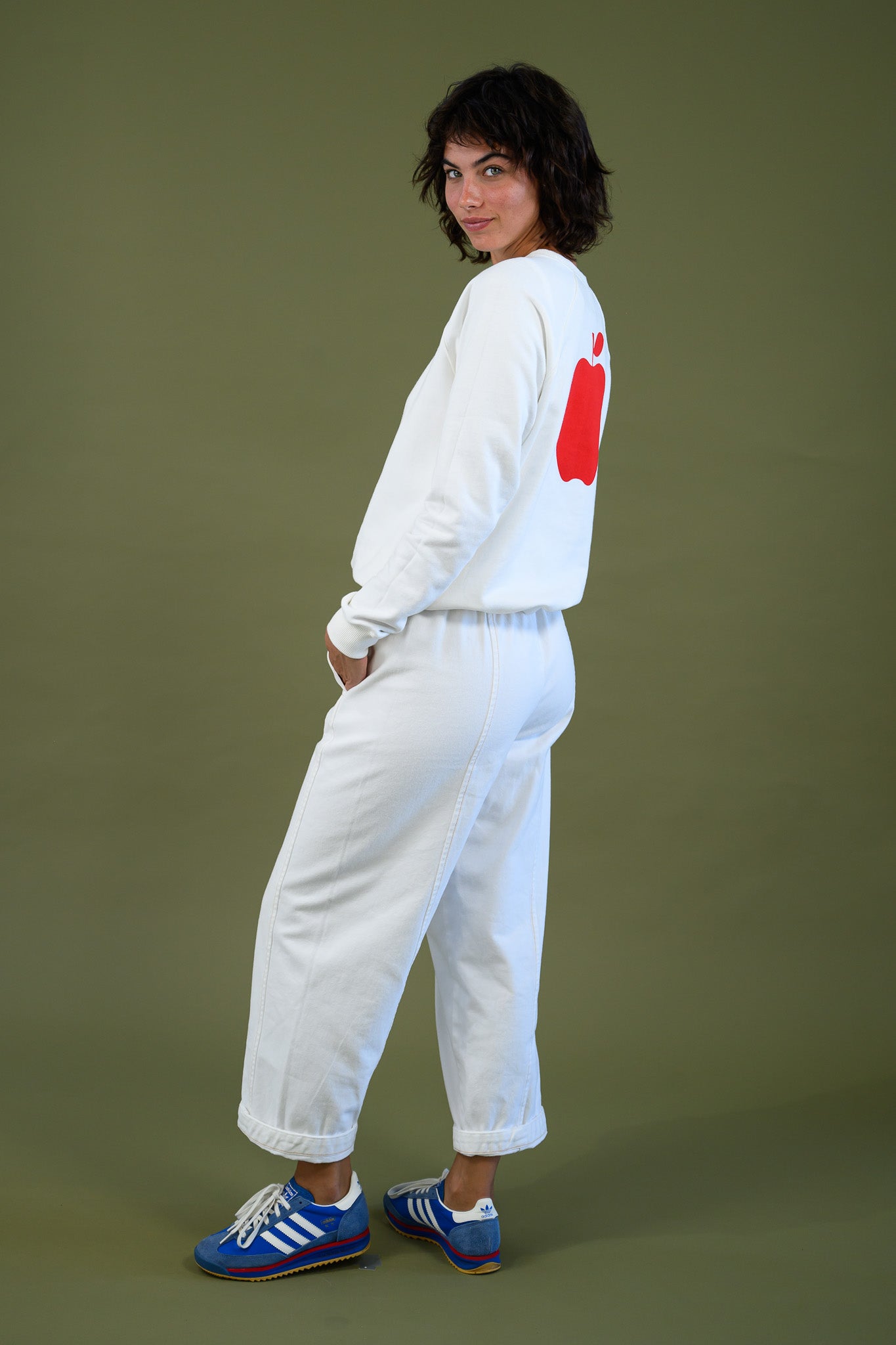 Side view of white cotton sweatshirt showing relaxed fit and silhouette