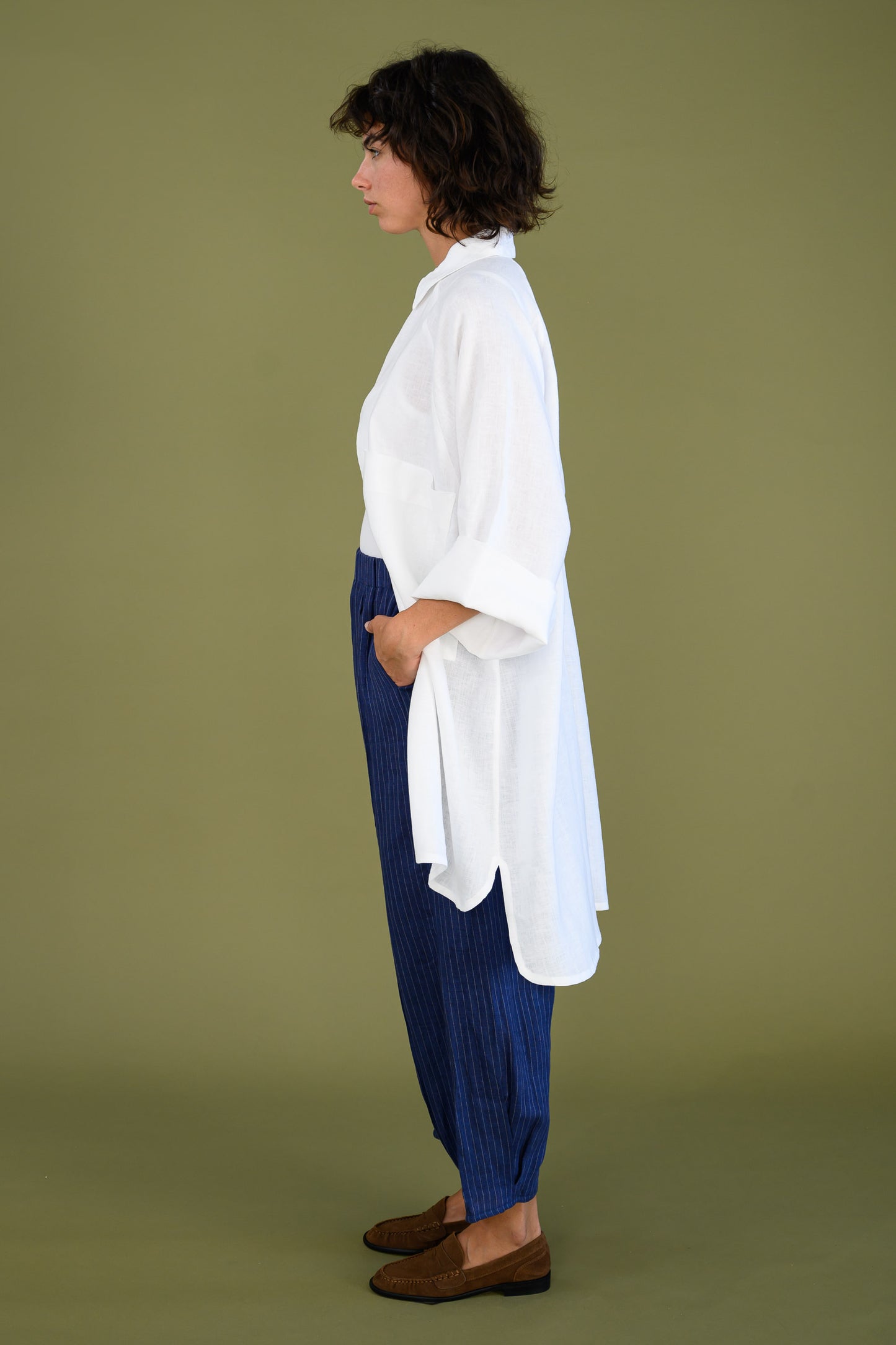 Side view of white linen shirt dress showing oversized fit and length
