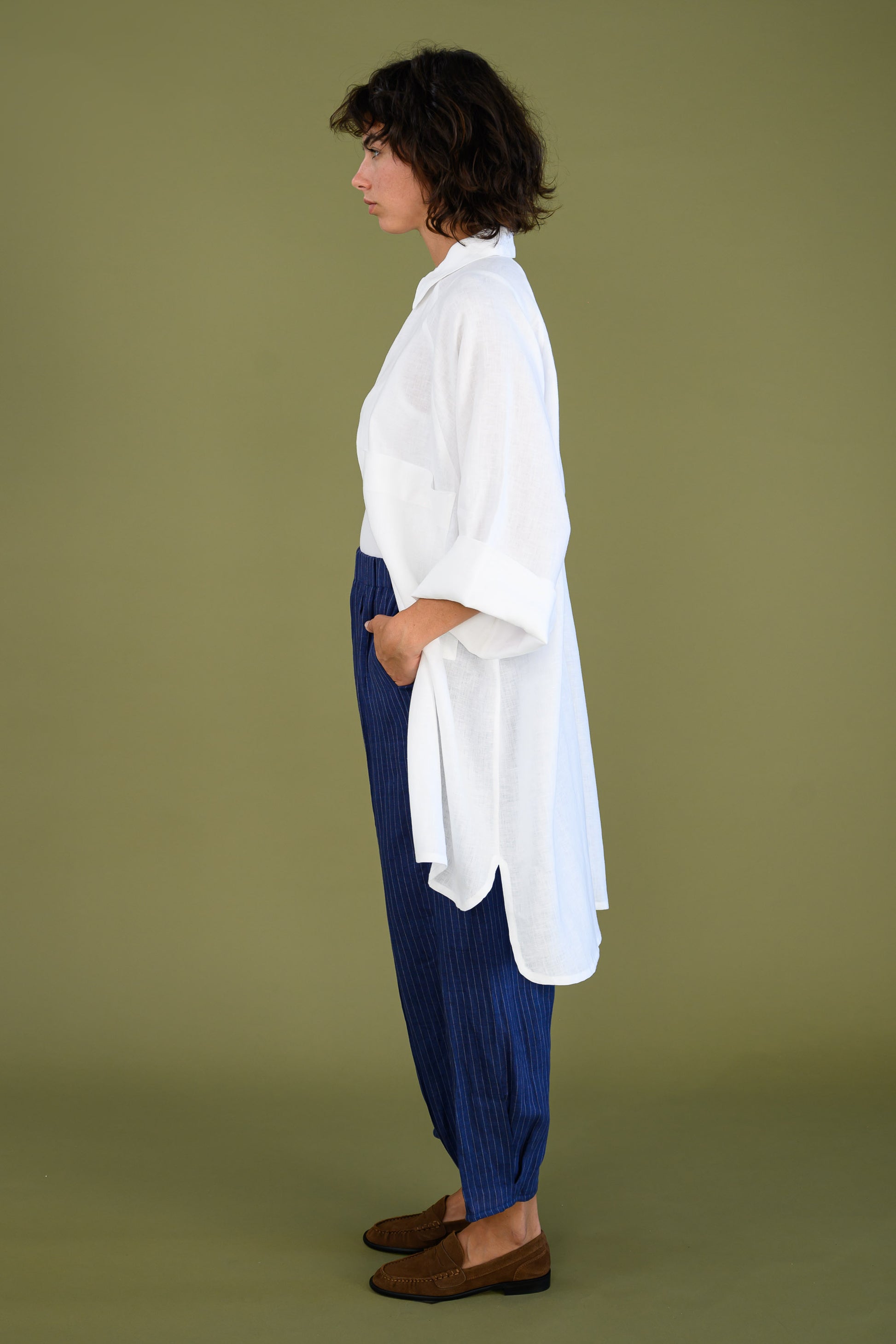 Side view of white linen shirt dress showing oversized fit and length